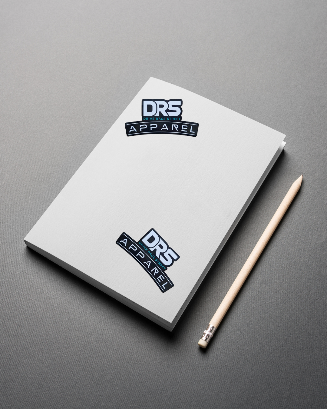 DRS Apparel official logo sticker in high-quality waterproof vinyl, featuring white and teal typography on a durable black background for automotive use, laptops, bottles, books.