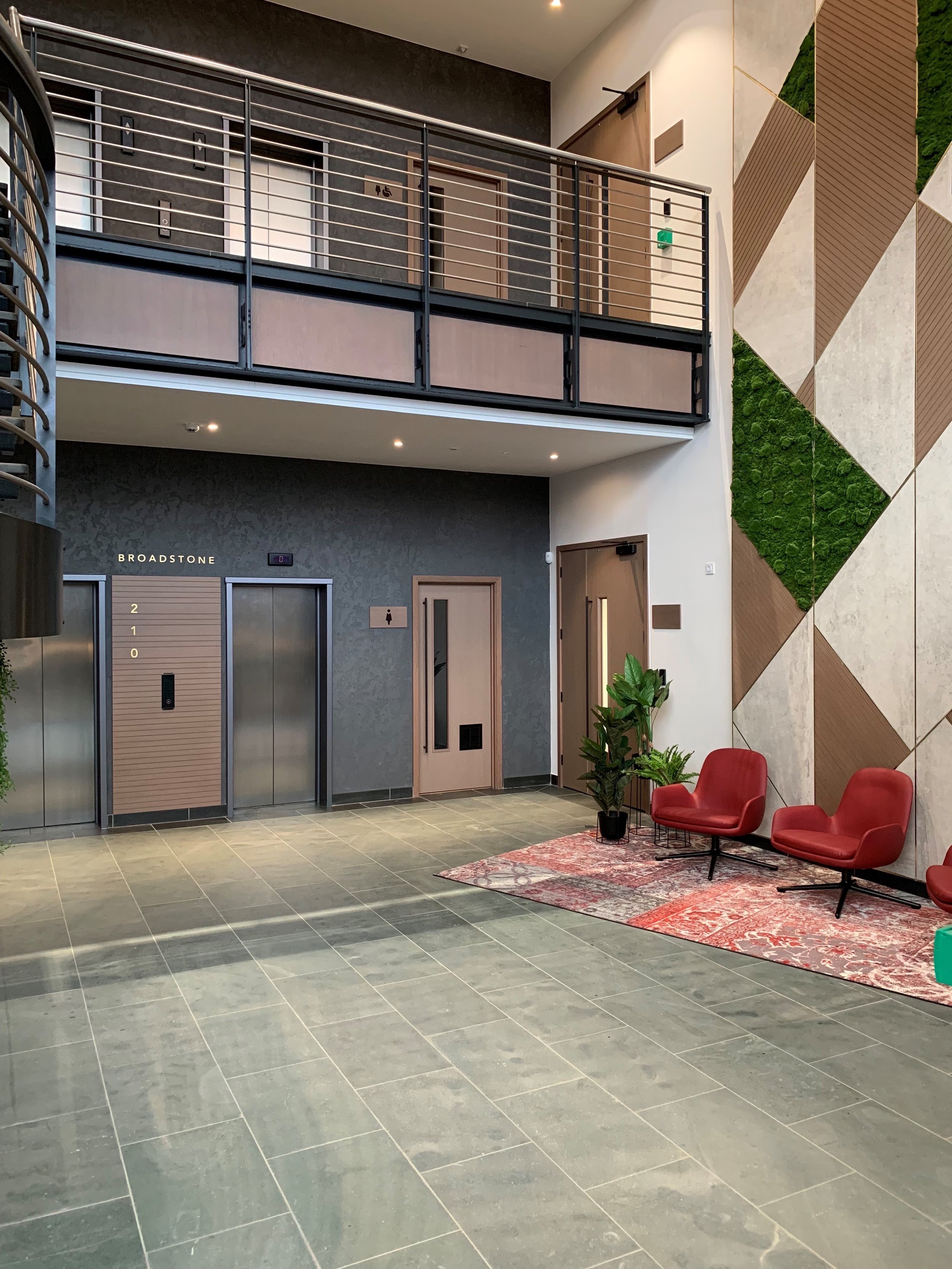 Public restroom with sinks, mirrors, and soap dispensers, part of an office fit-out by GM Projects.