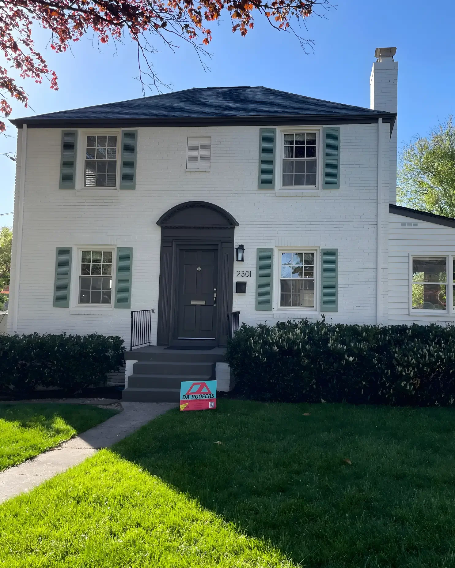 A finished roofing job with DA'Roofers sign in the frontyard in Maryland