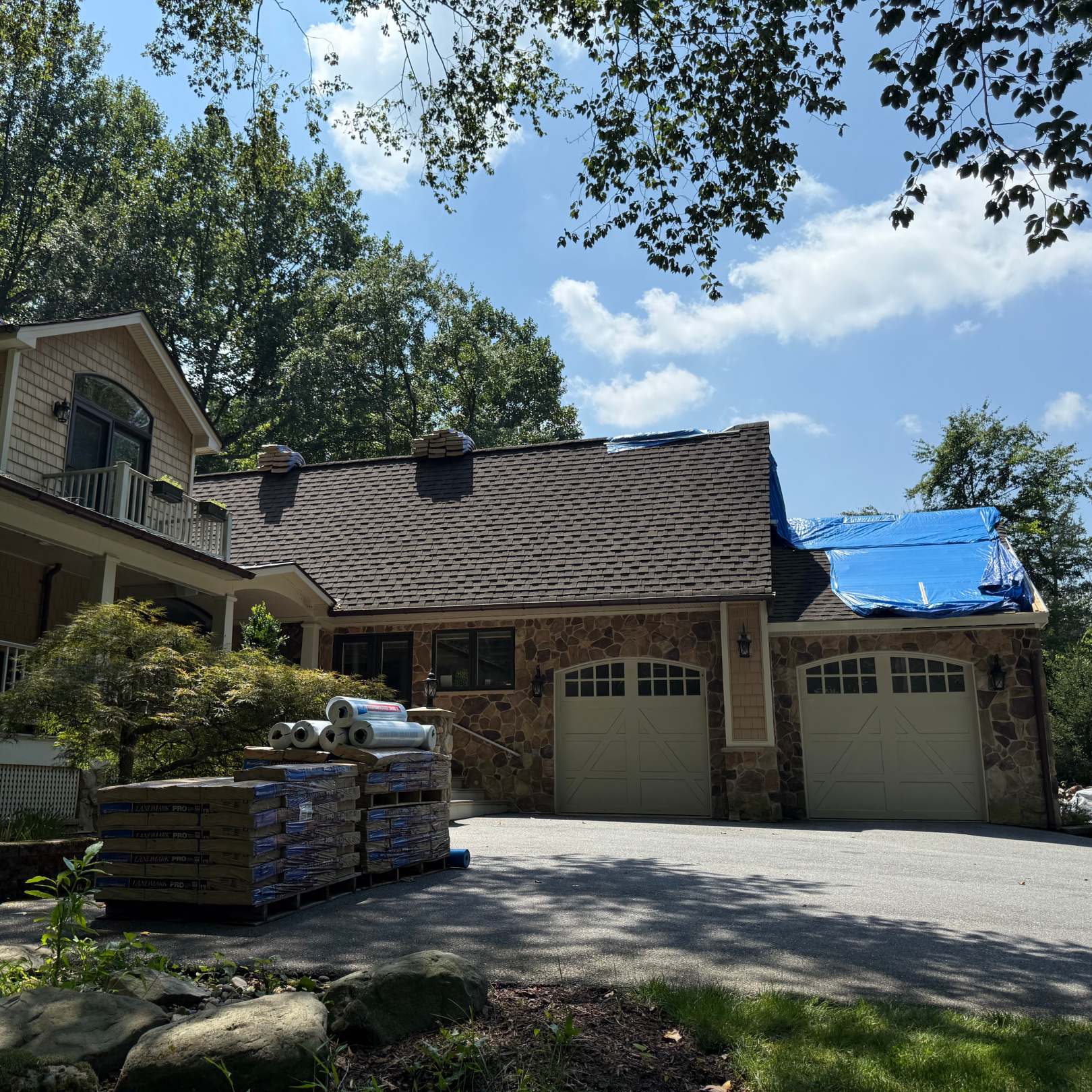 Clear driveway with roofing materials ready