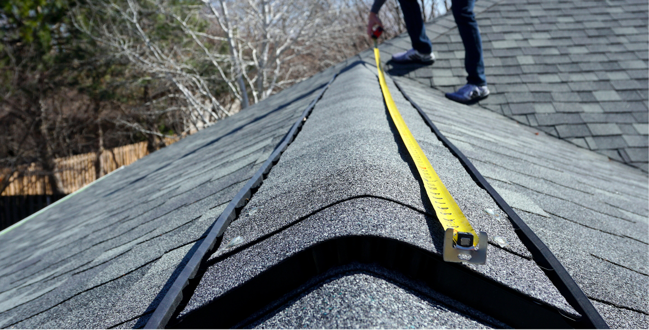 Professional DMV roofing contractor securing ridge caps on a residential roof for weather protection.
