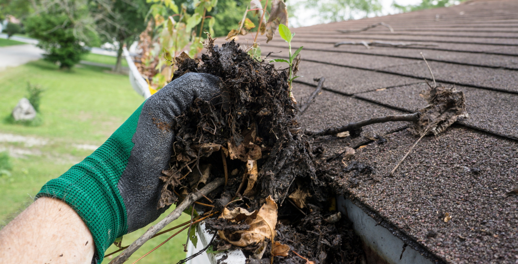 Cleaning roof gutters during seasonal maintenance in the Maryland