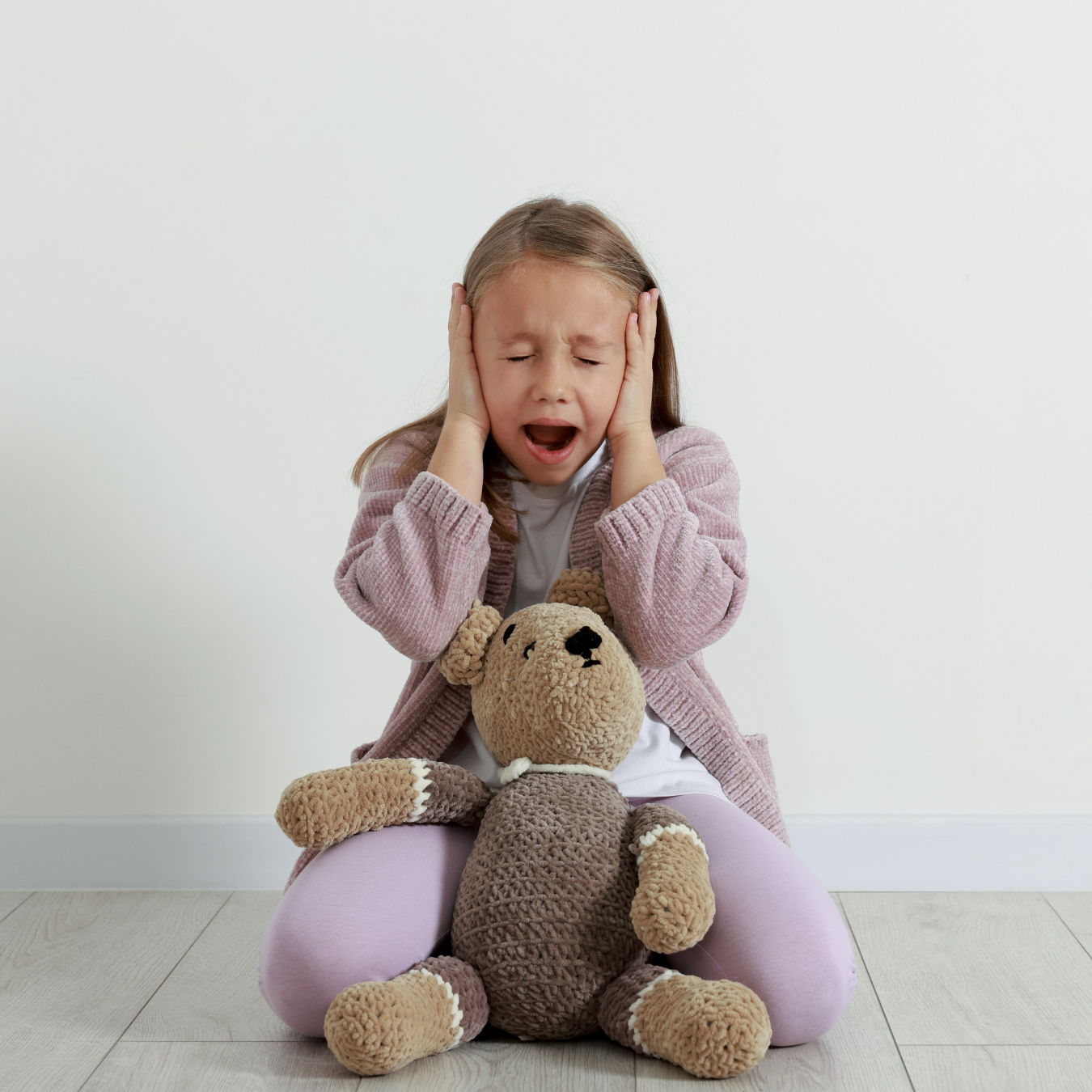 Kid covering ears due to stormy, loud rainfall