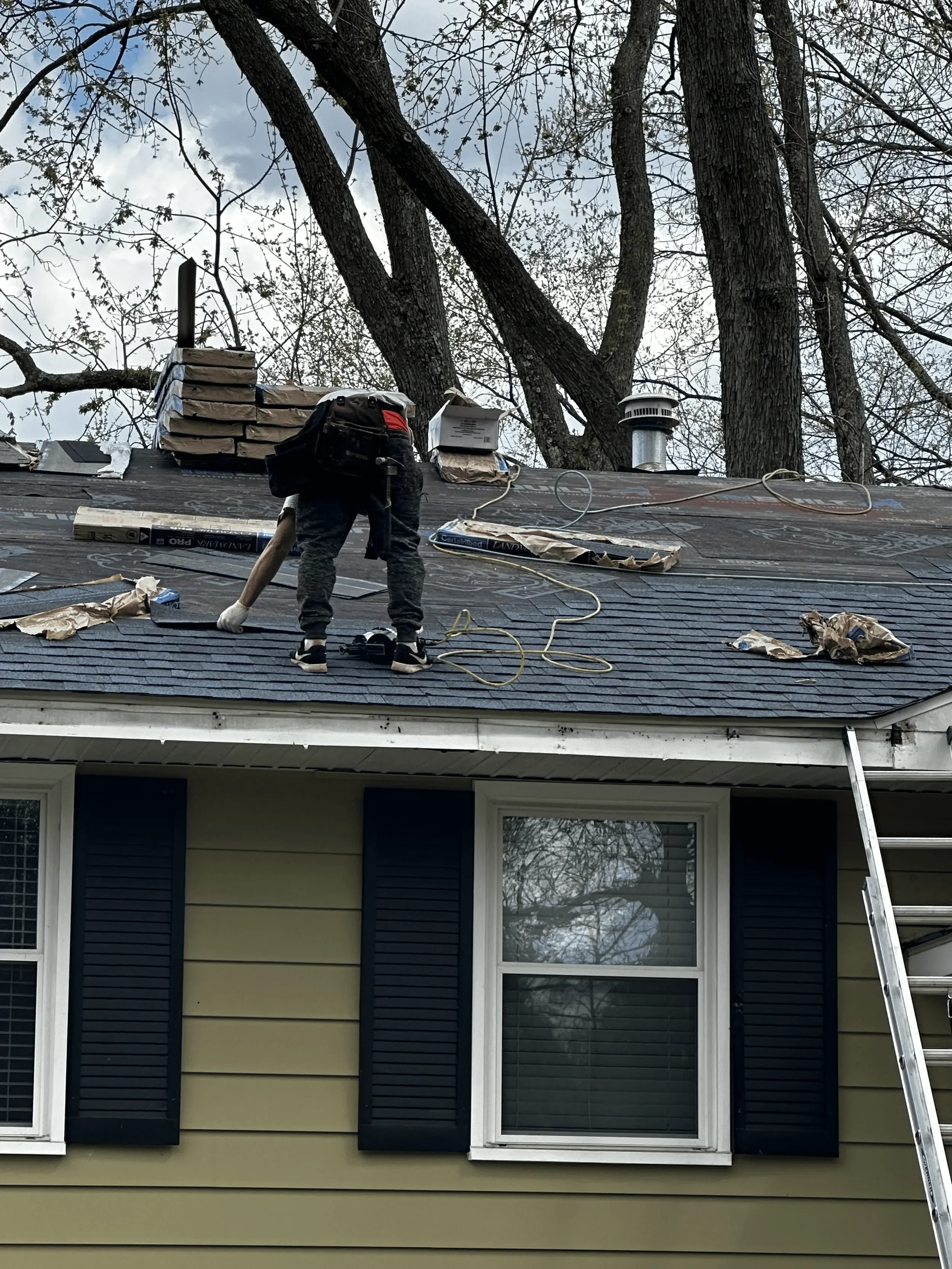 DA Roofers working on a gray roof 