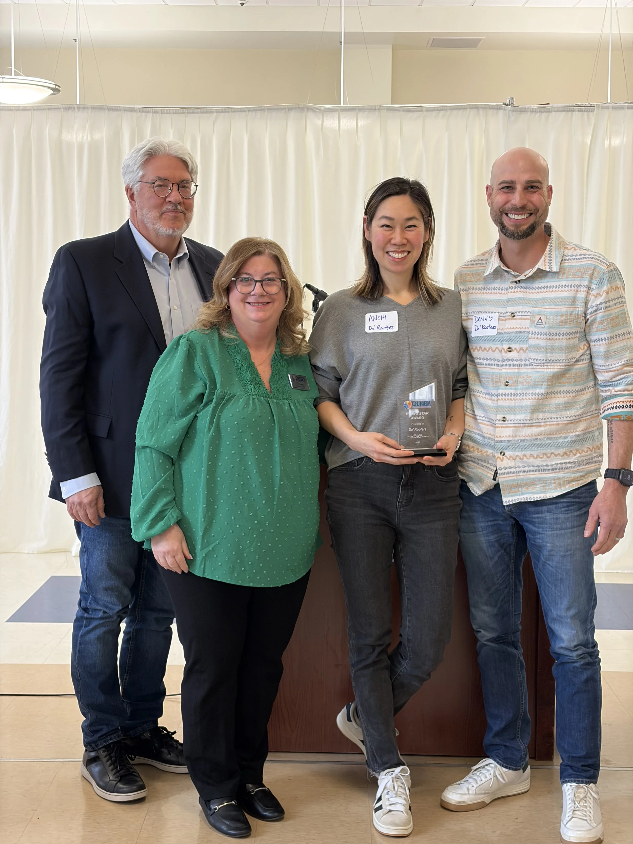 Da' Roofers team accepting the Rising Star Business Award from the Olney Chamber of Commerce in Maryland.