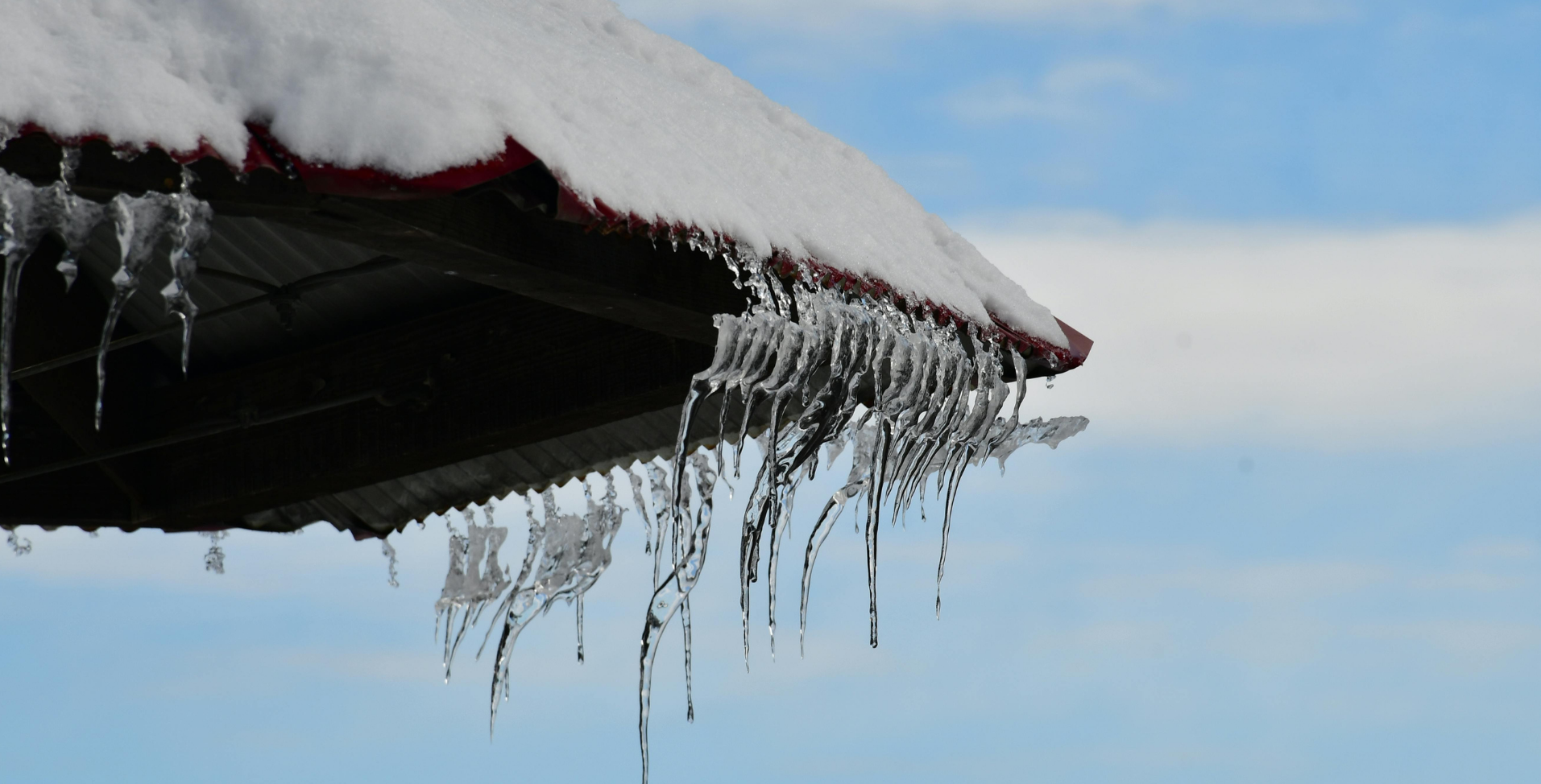 Ice dams forming on a roof requiring maintenance