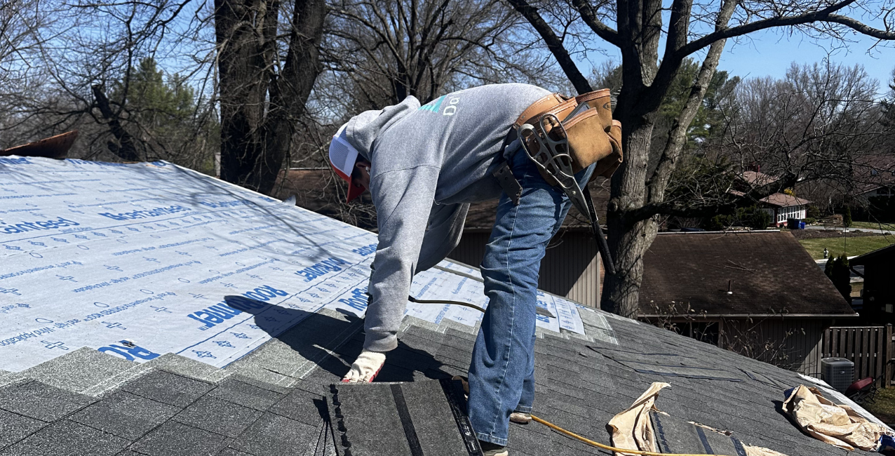 DMV Roofer installing architectural asphalt shingles over synthetic roof underlayment during a residential roof replacement