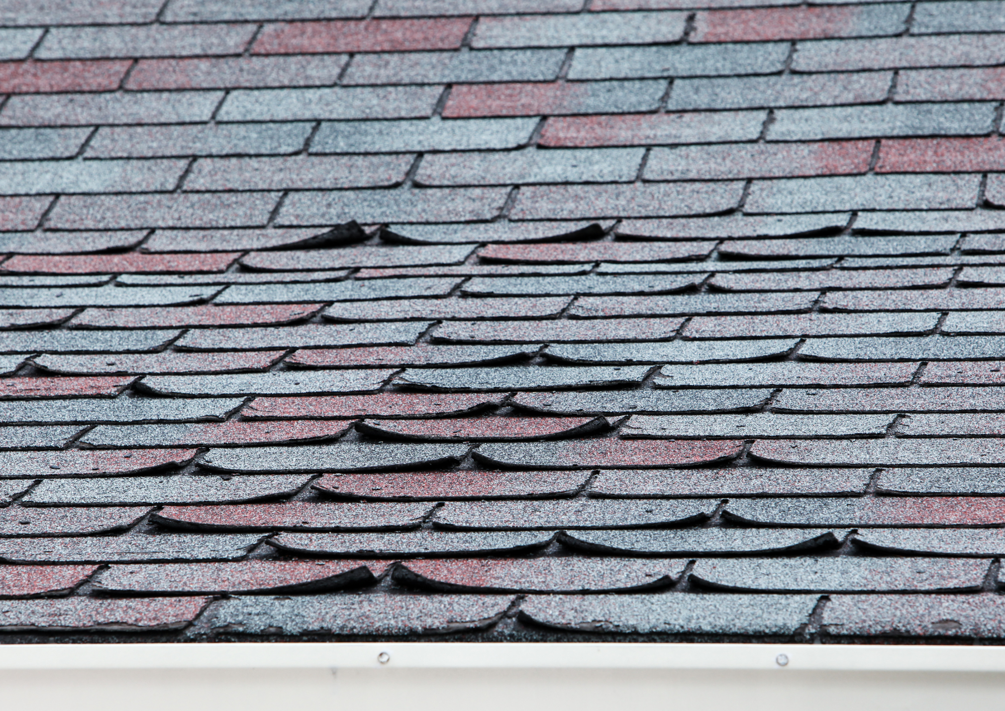 Close-up of roof with uneven color and aging shingles