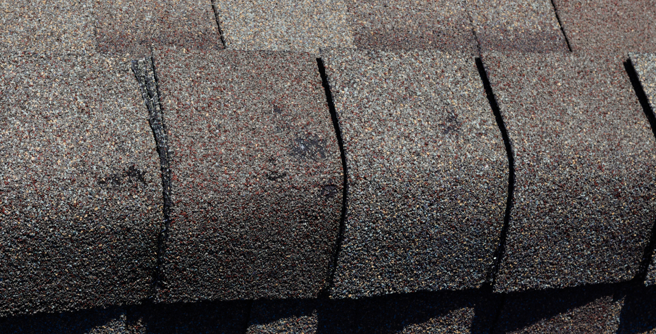 Hail-damaged residential roof in need of repair