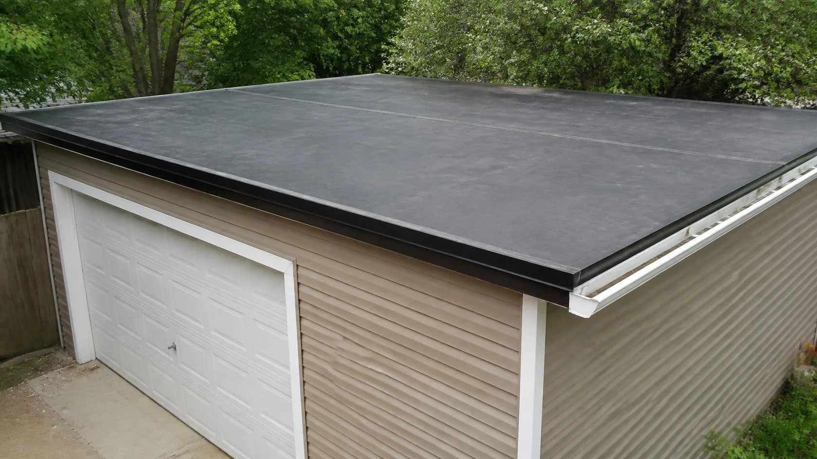 A black EPDM rubber membrane roof over a garage on a Maryland home.