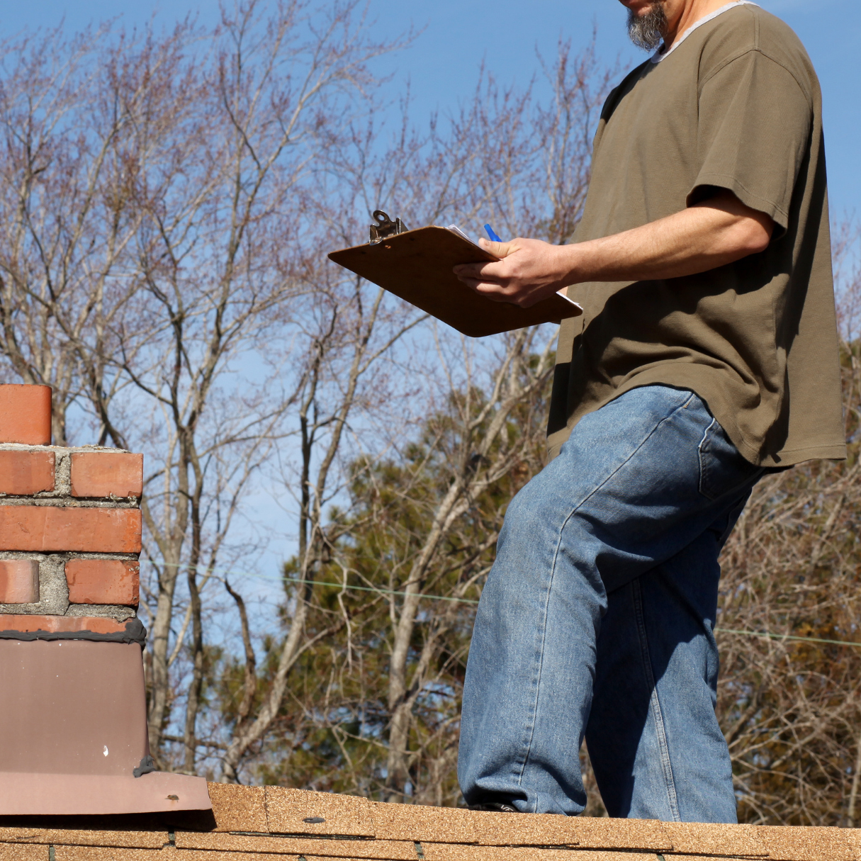 DMV Insurance adjuster inspecting a residential roof for damage