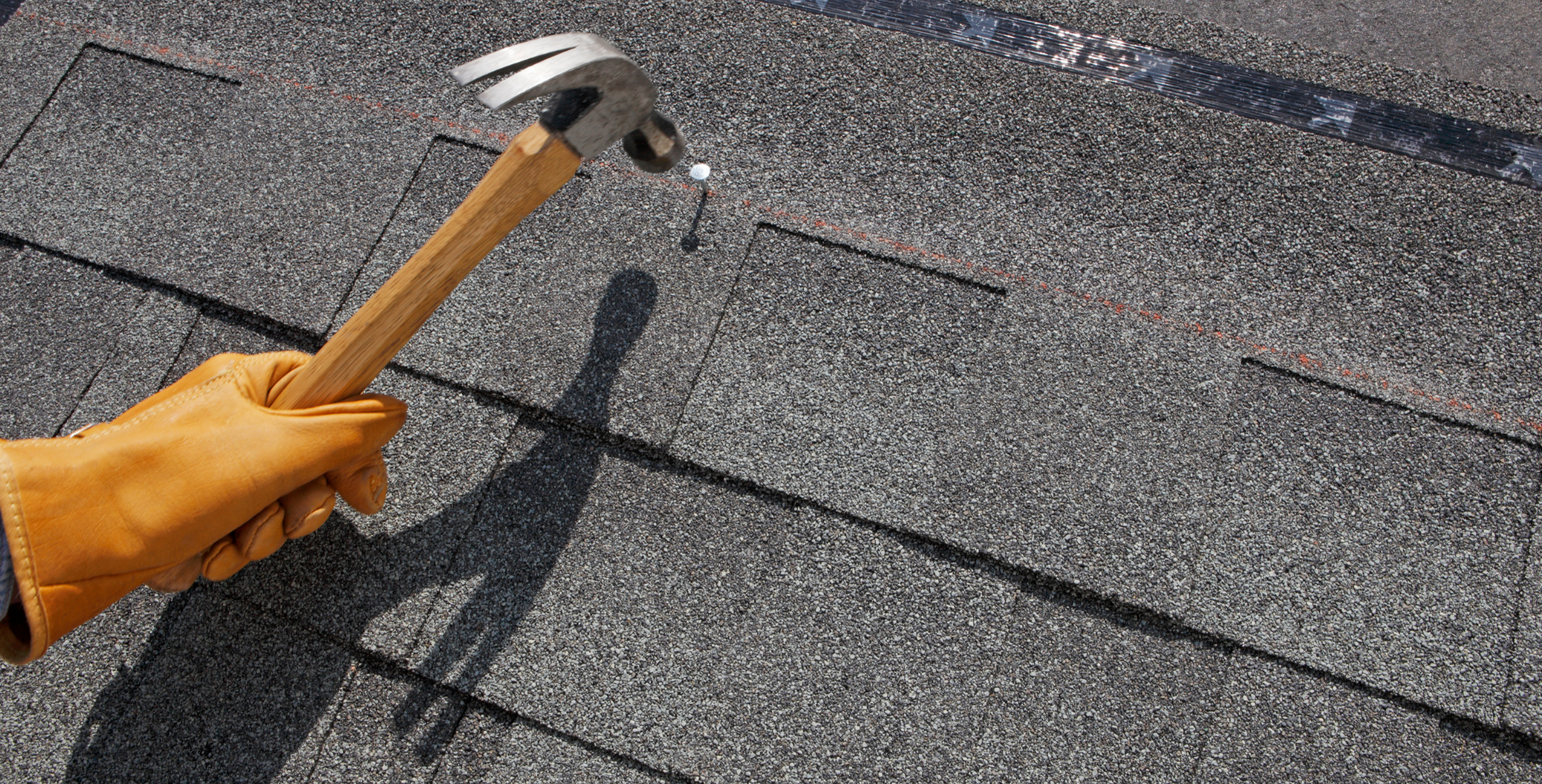 Roofer installing shingles during a roof over project