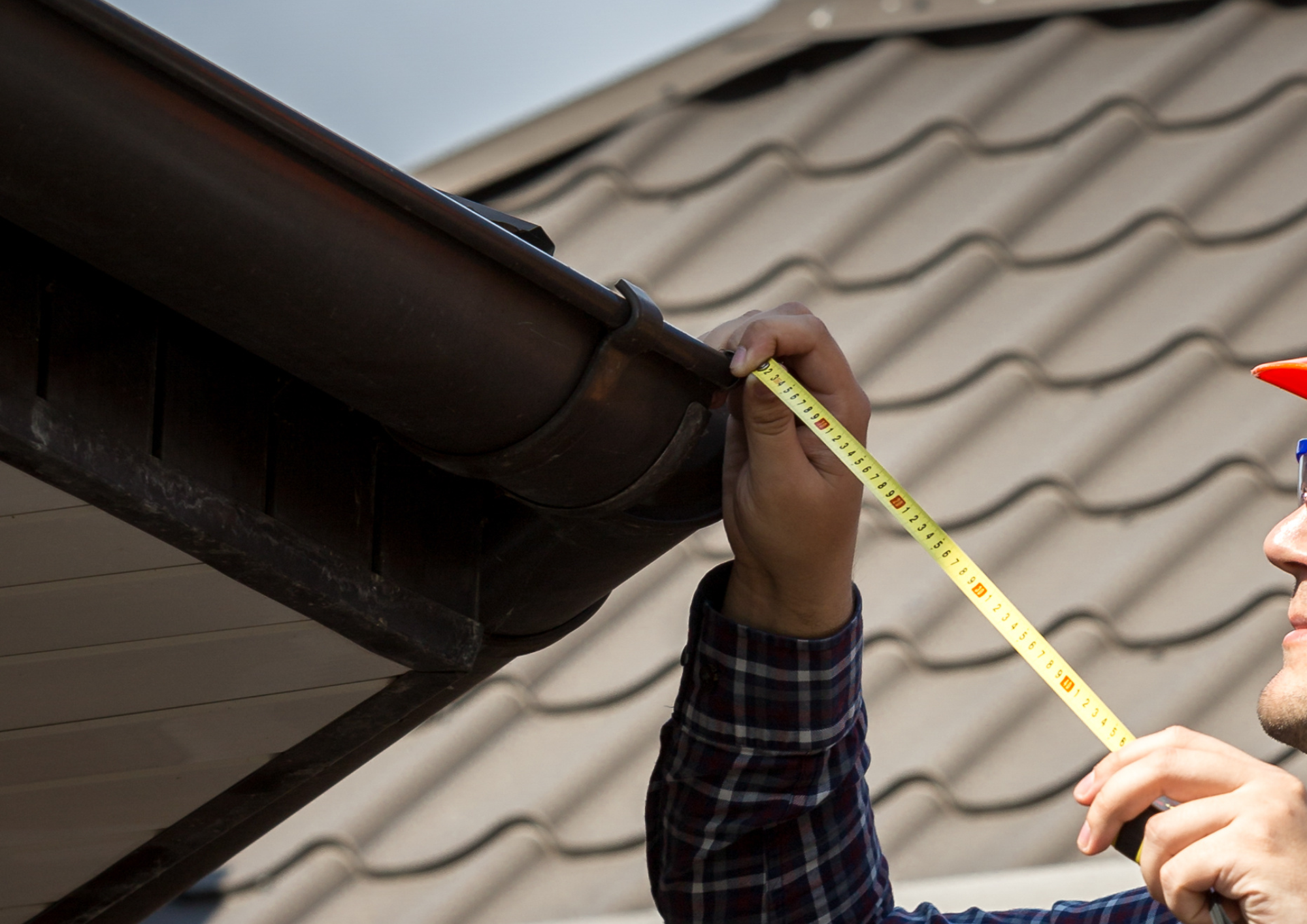 Close-up of a professional inspecting a roof during an audit