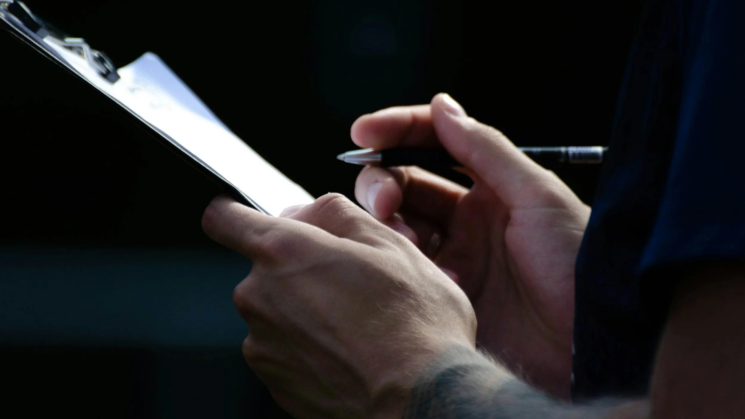 A contracting holding a pen