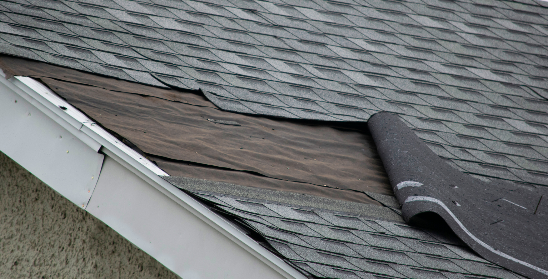 Roof damage caused by severe storm showing missing shingles
