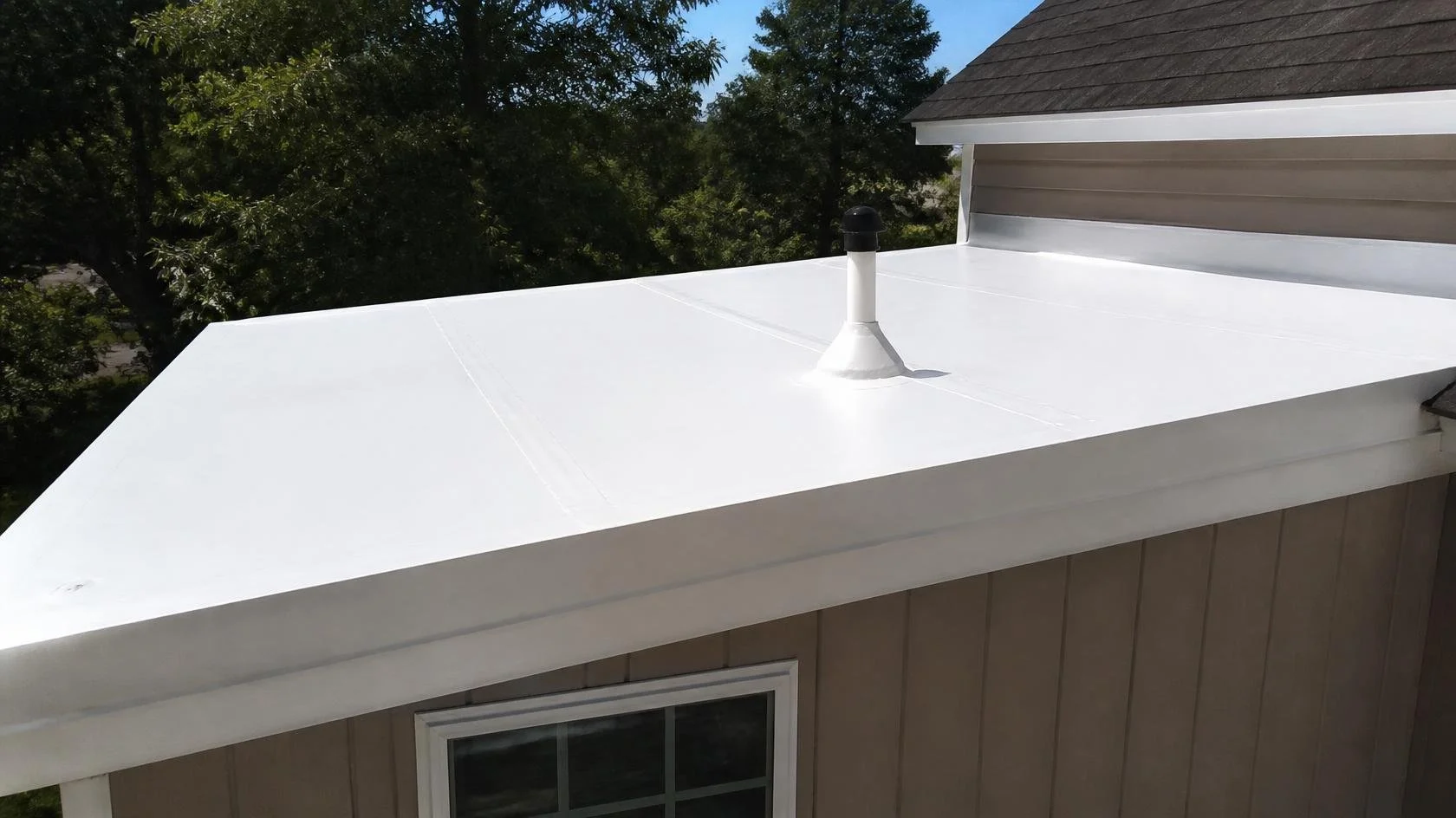 A white TPO membrane roof over a bedroom addition on a Maryland home.