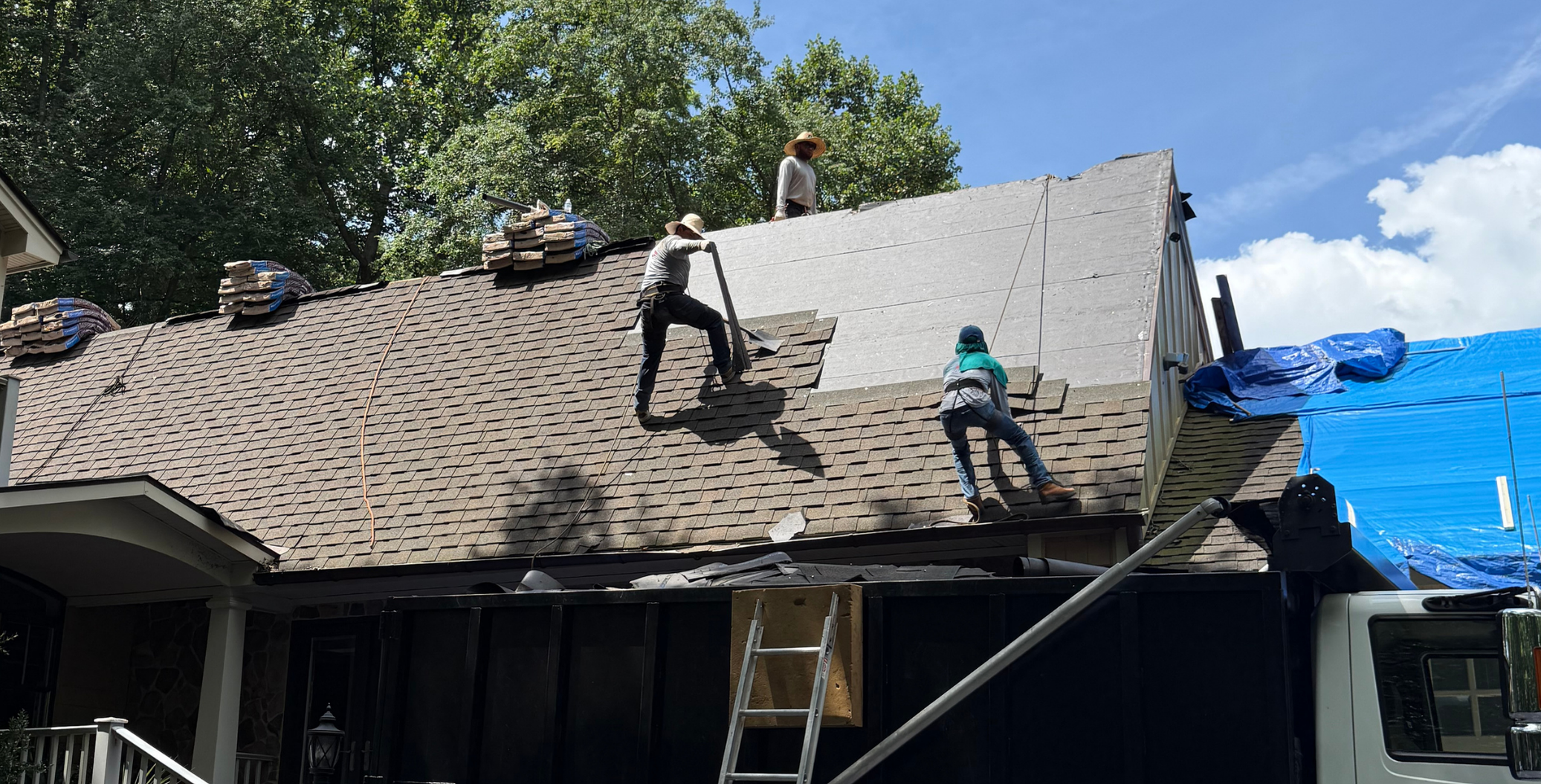 Da' Roofers team installing shingles on a home roof