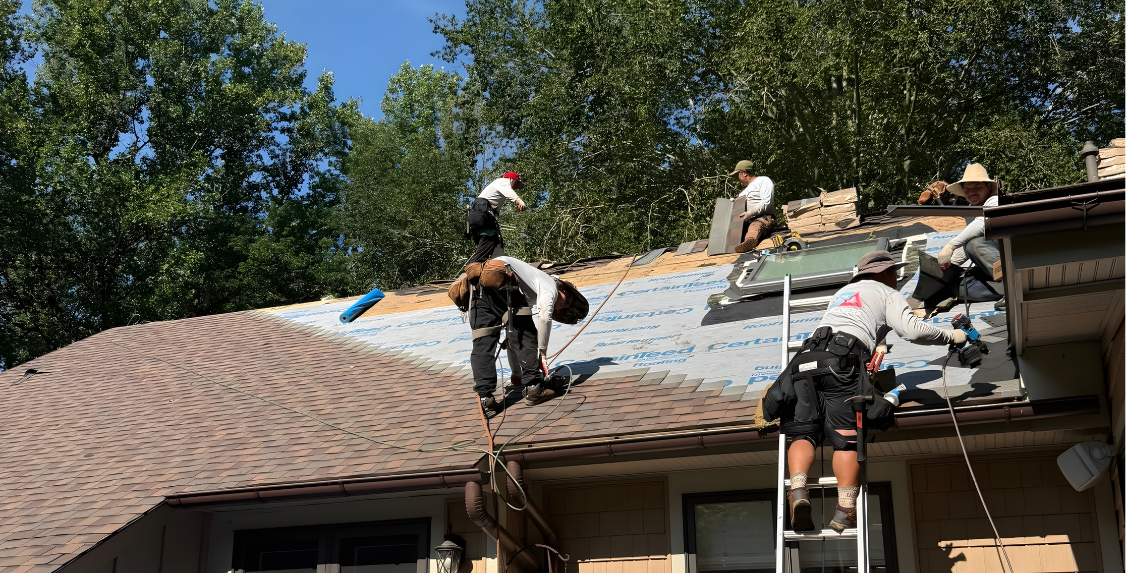 Roofing contractors working on residential roof in the DMV area