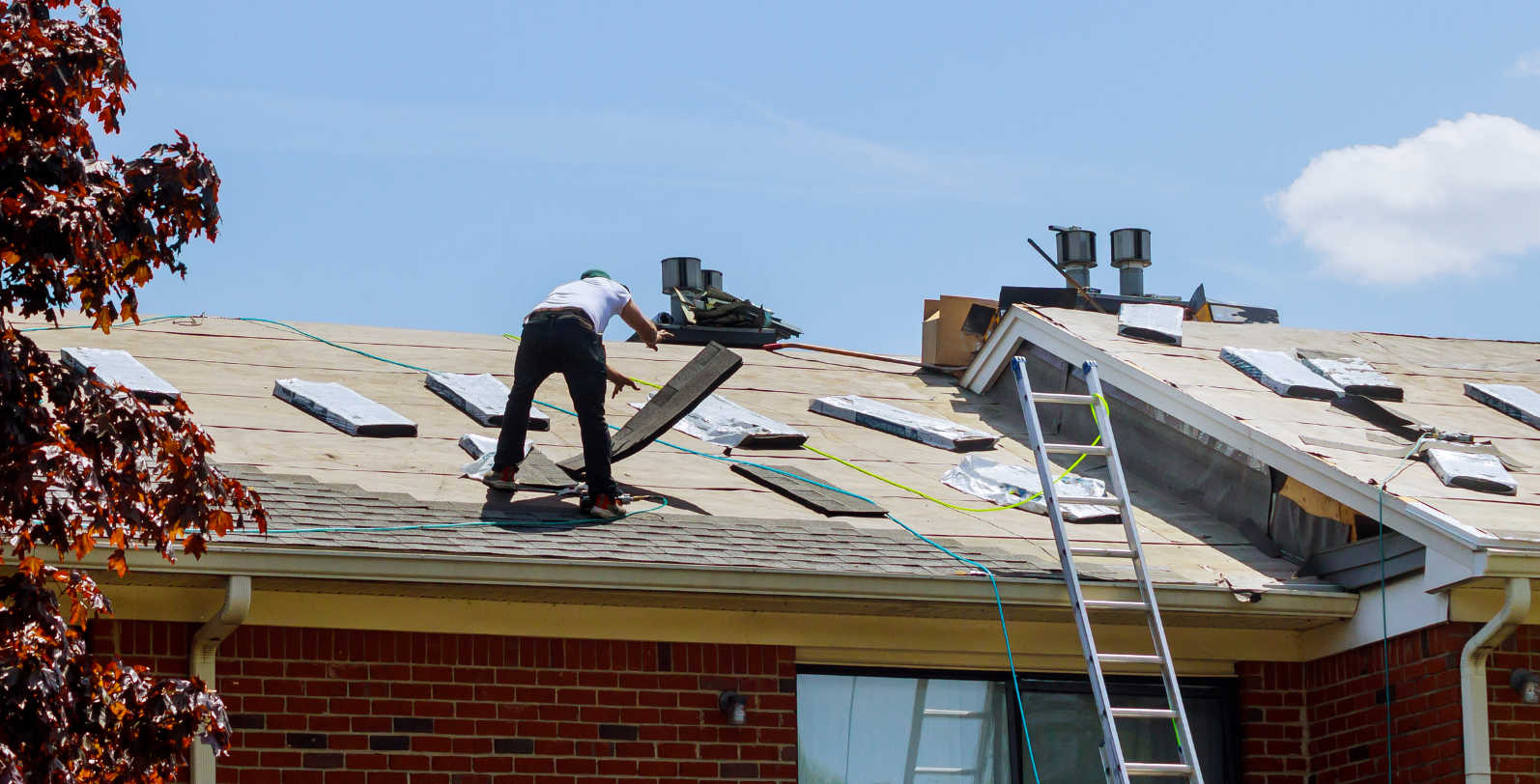 Roofer replacing a residential roof in the DMV area