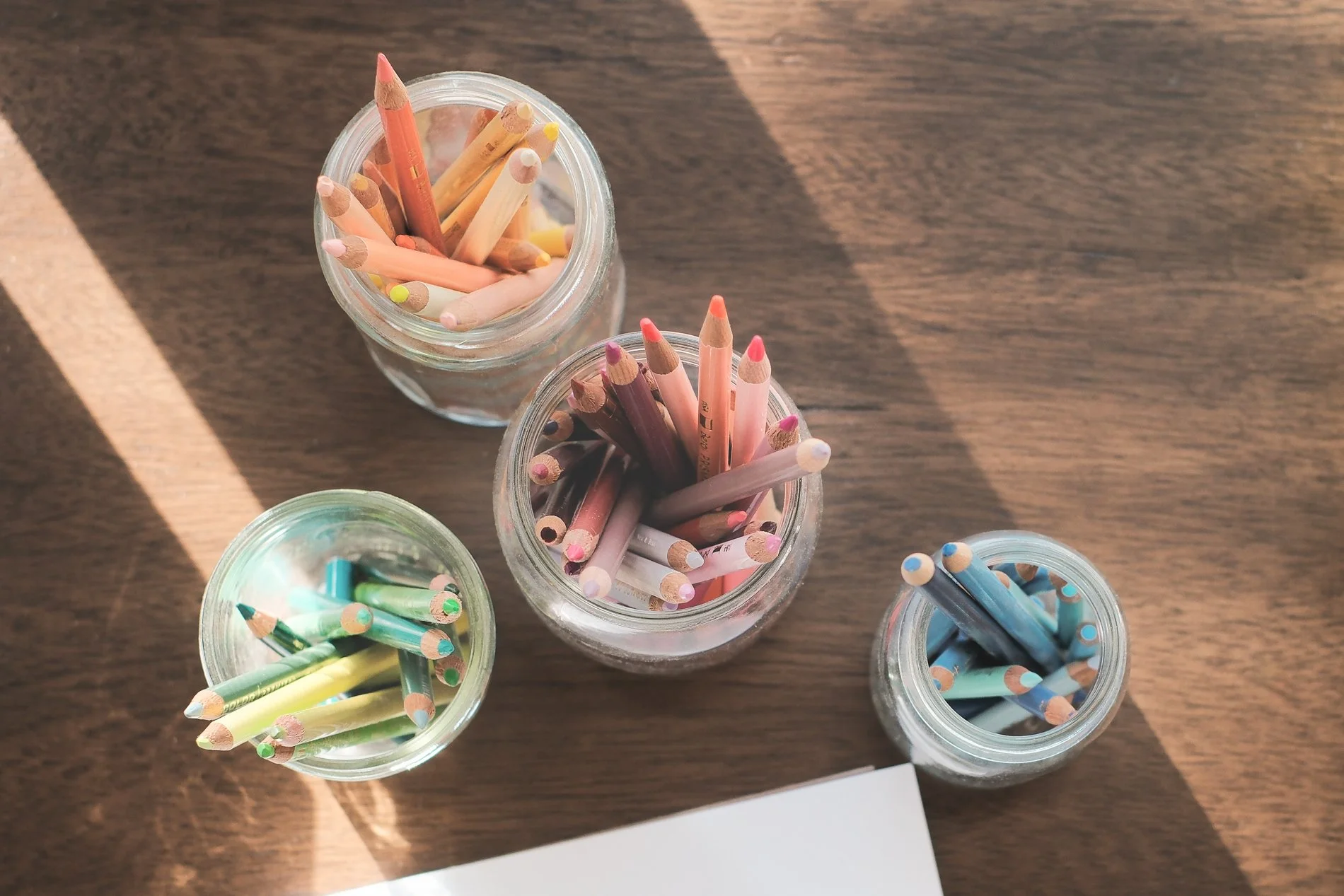 jars of colored pencils on desk