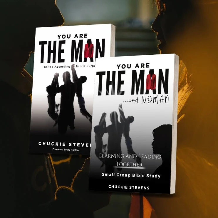 Two books titled 'You Are the Man' by Chuckie Stevens, one with a subtitle '…and Woman', featuring silhouettes of people in the background, held by two individuals with side profiles visible.