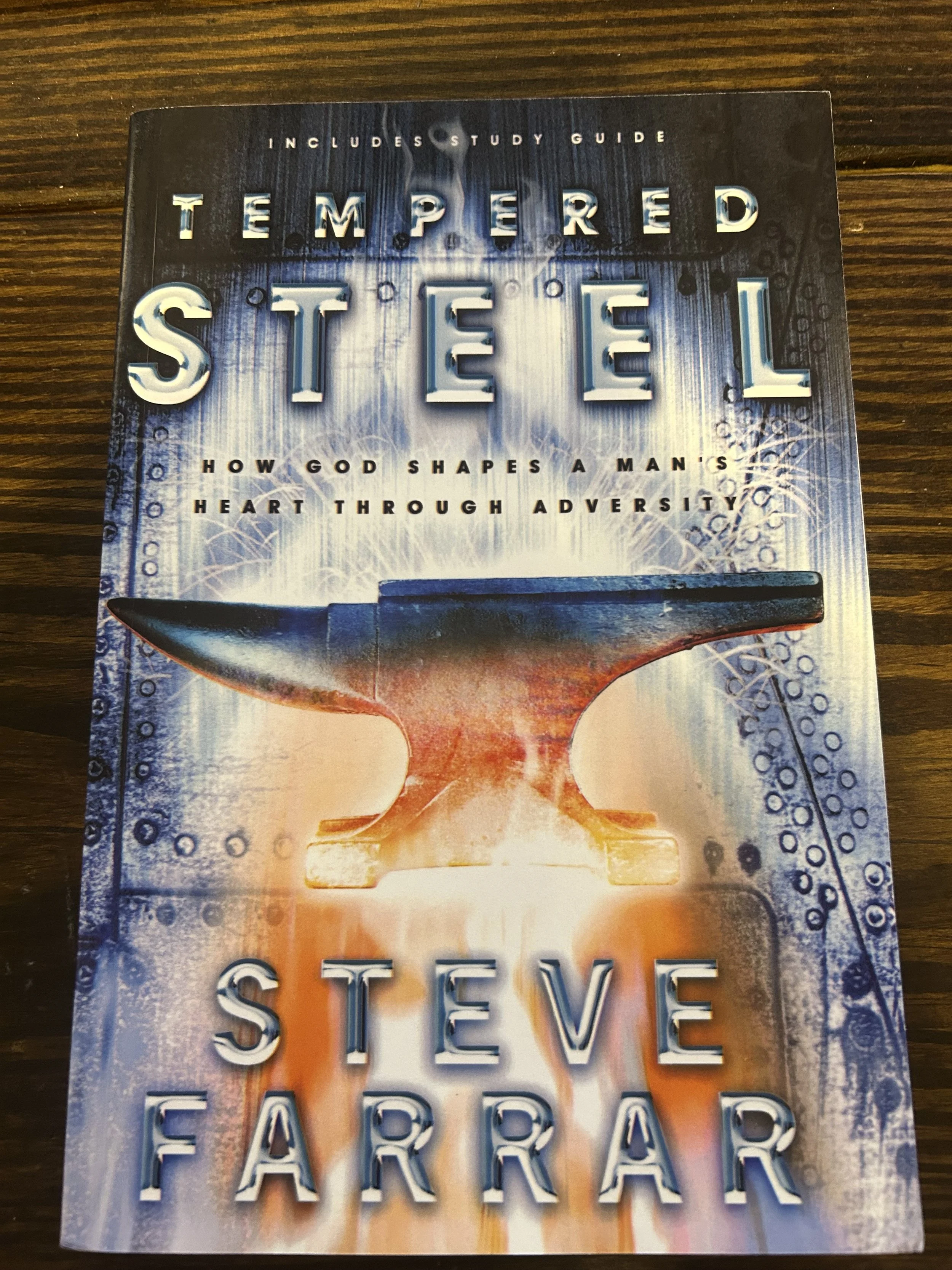 Book cover titled 'Tempered Steel' by Steve Farrar, featuring an anvil with glowing fire and sparks, and subtitle 'How God Shapes a Man's Heart Through Adversity'.