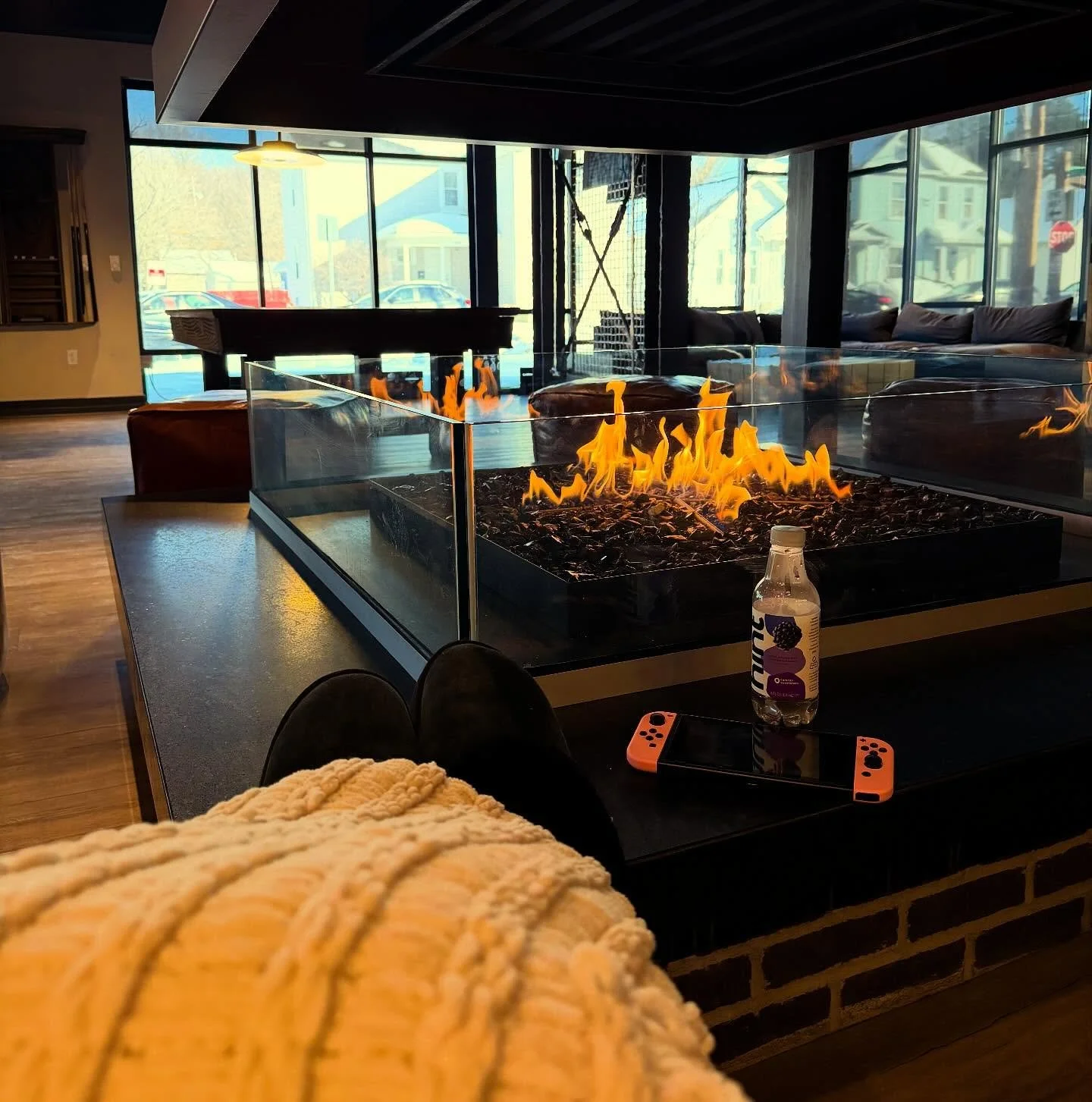 Our clubhouse fireplace understood the assignment! Warm up, take a tour, and picture yourself here. Two- and four-bedroom spots still available for next year! #theflight #flightliving #apartmentgoals