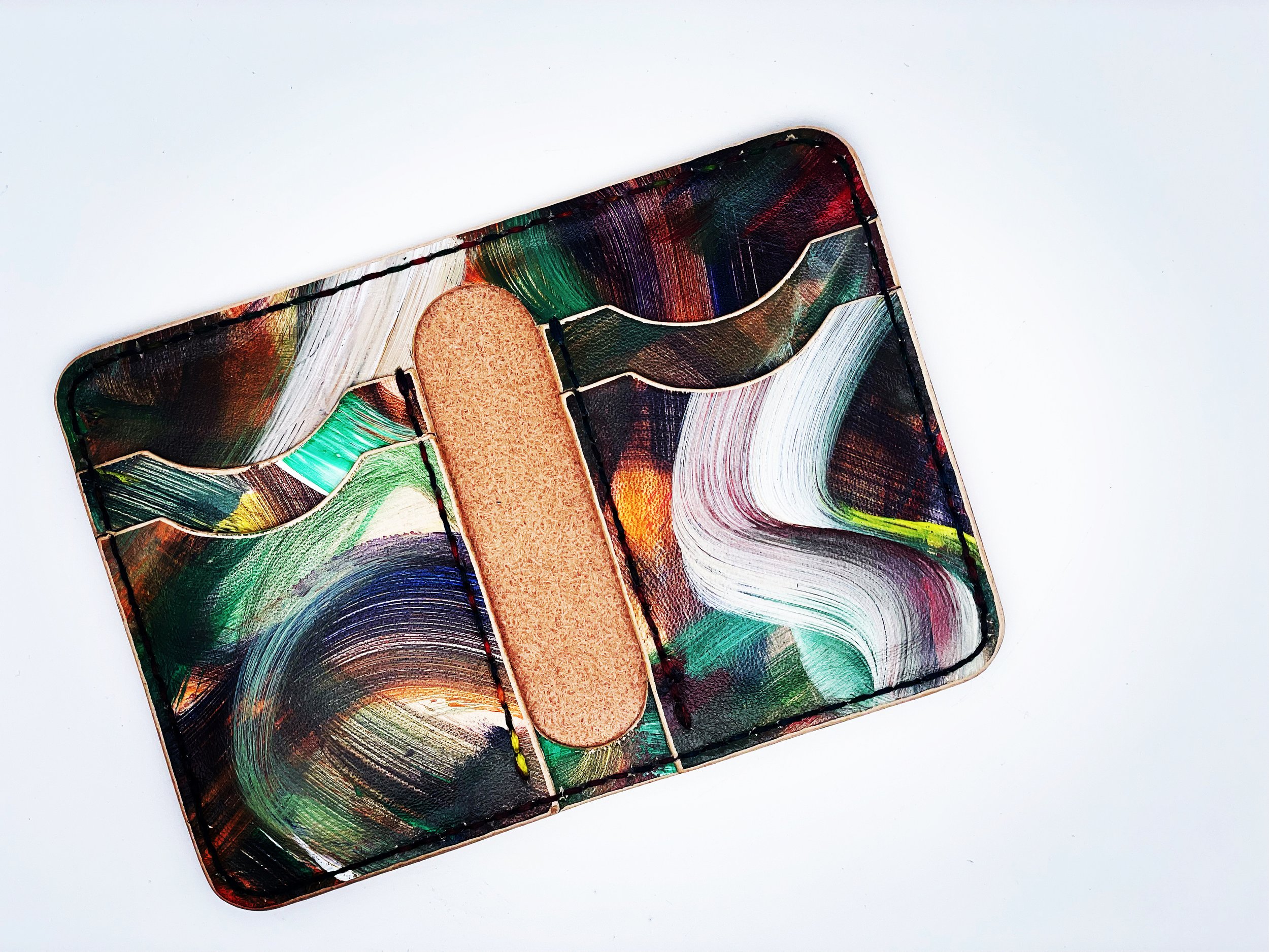 A rectangular container with abstract, colorful swirling patterns and a strip of cardboard inside.