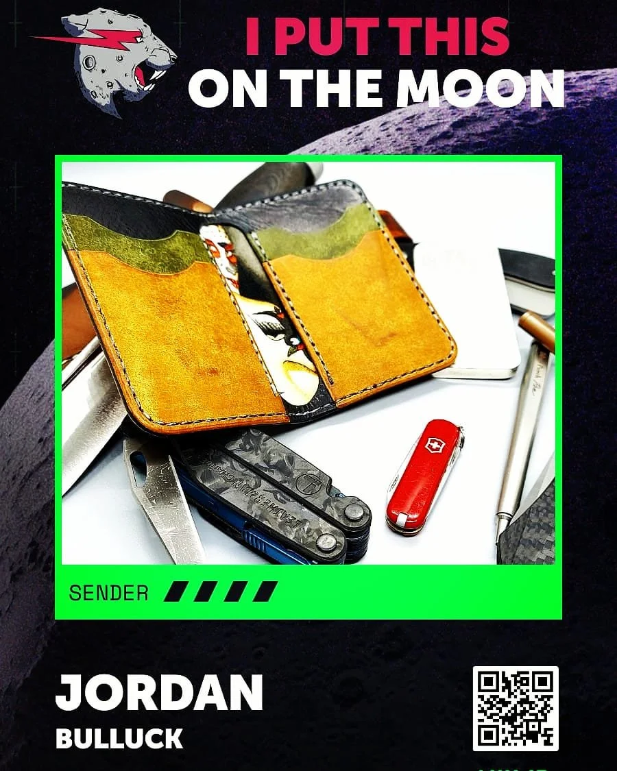 A collage of everyday personal items including a yellow and black wallet, multitool, Swiss Army knife, red Swiss Army pocket knife, silver pen, and a white object. The background features moon and space-themed graphics with text "I PUT THIS ON THE MO