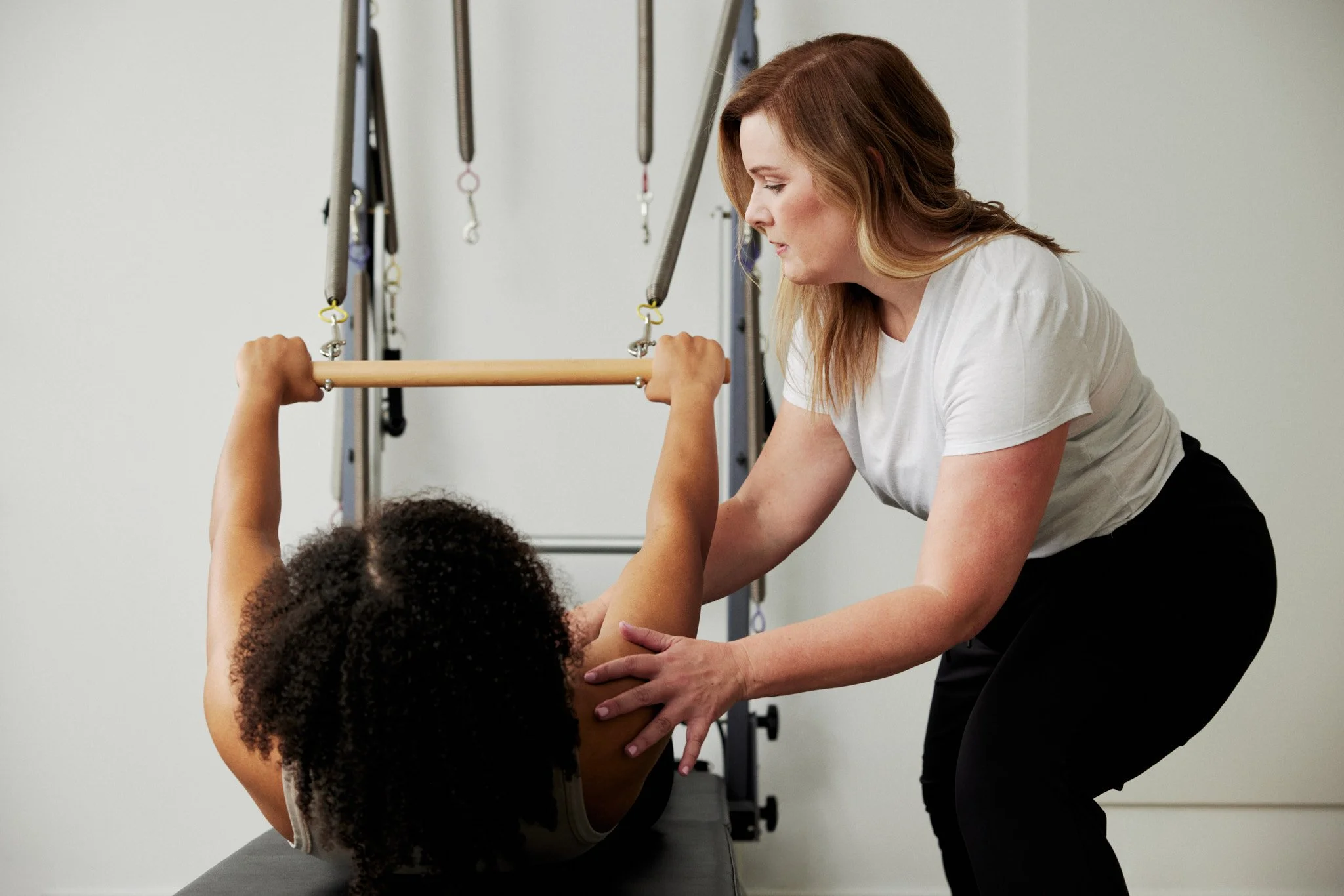 Physiotherapist leading movement-based rehabilitation using clinical Pilates