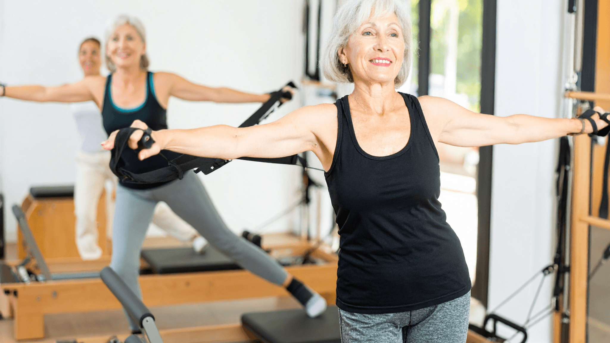 Physiotherapist guiding a client through clinical Pilates movement therapy in East Vancouver