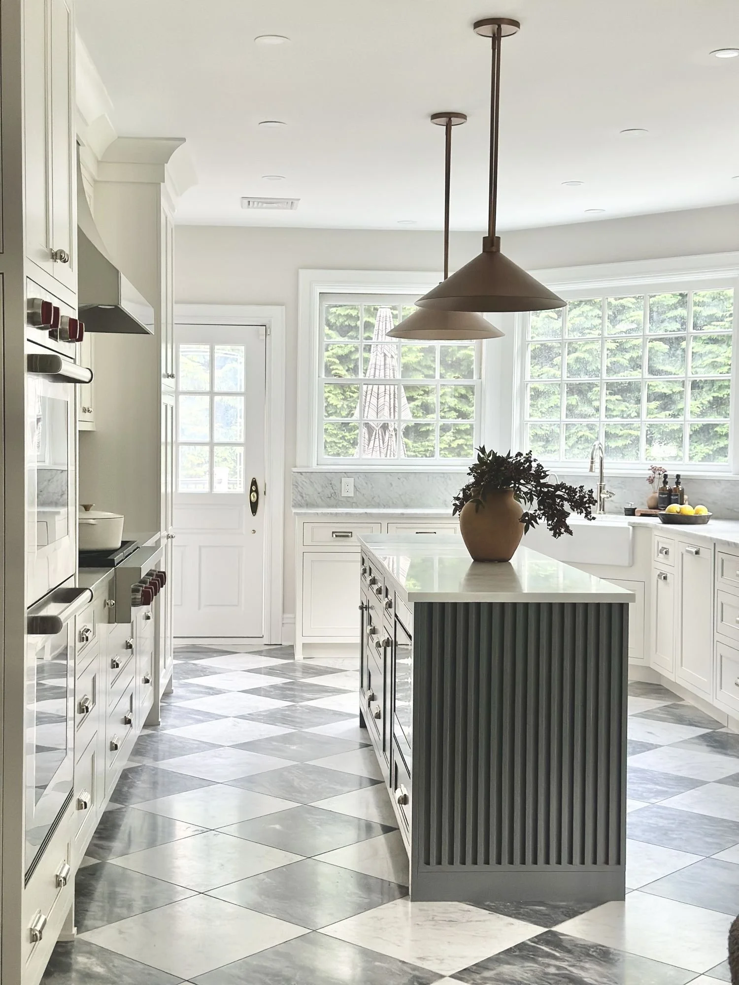 Kitchen with a fluted green island and checkered marble floor | Lily & Nest Homes, New Jersey interior design