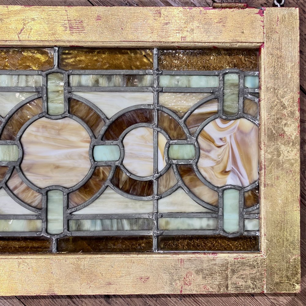 Green and Gold Stained Glass Window with Interwoven Loops and Gold Leafed Frame - Aurora Mills