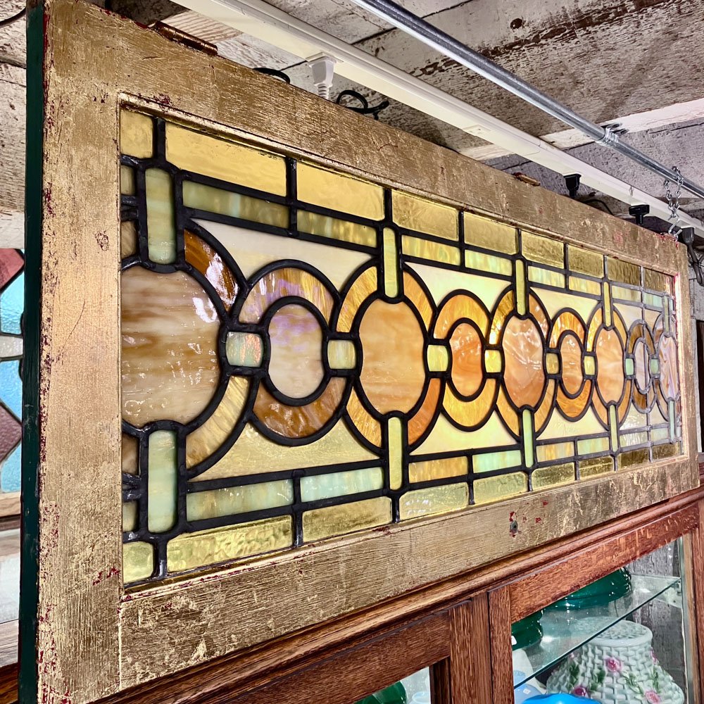 Green and Gold Stained Glass Window with Interwoven Loops and Gold Leafed Frame - Aurora Mills