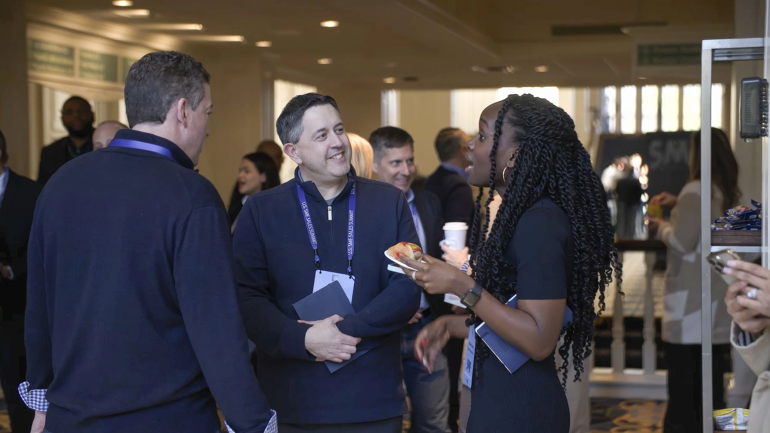 Man and woman talking at a conference.