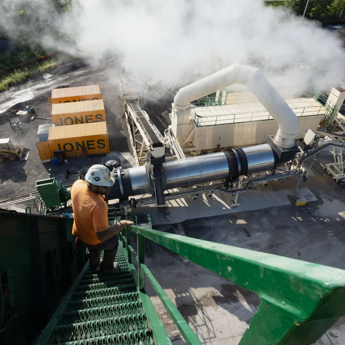 Man inspecting an asphalt plant during interstate construction.