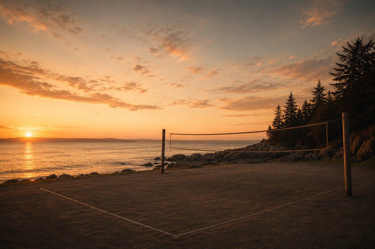 Empty sand volleyball court and net in warm golden-hour light.