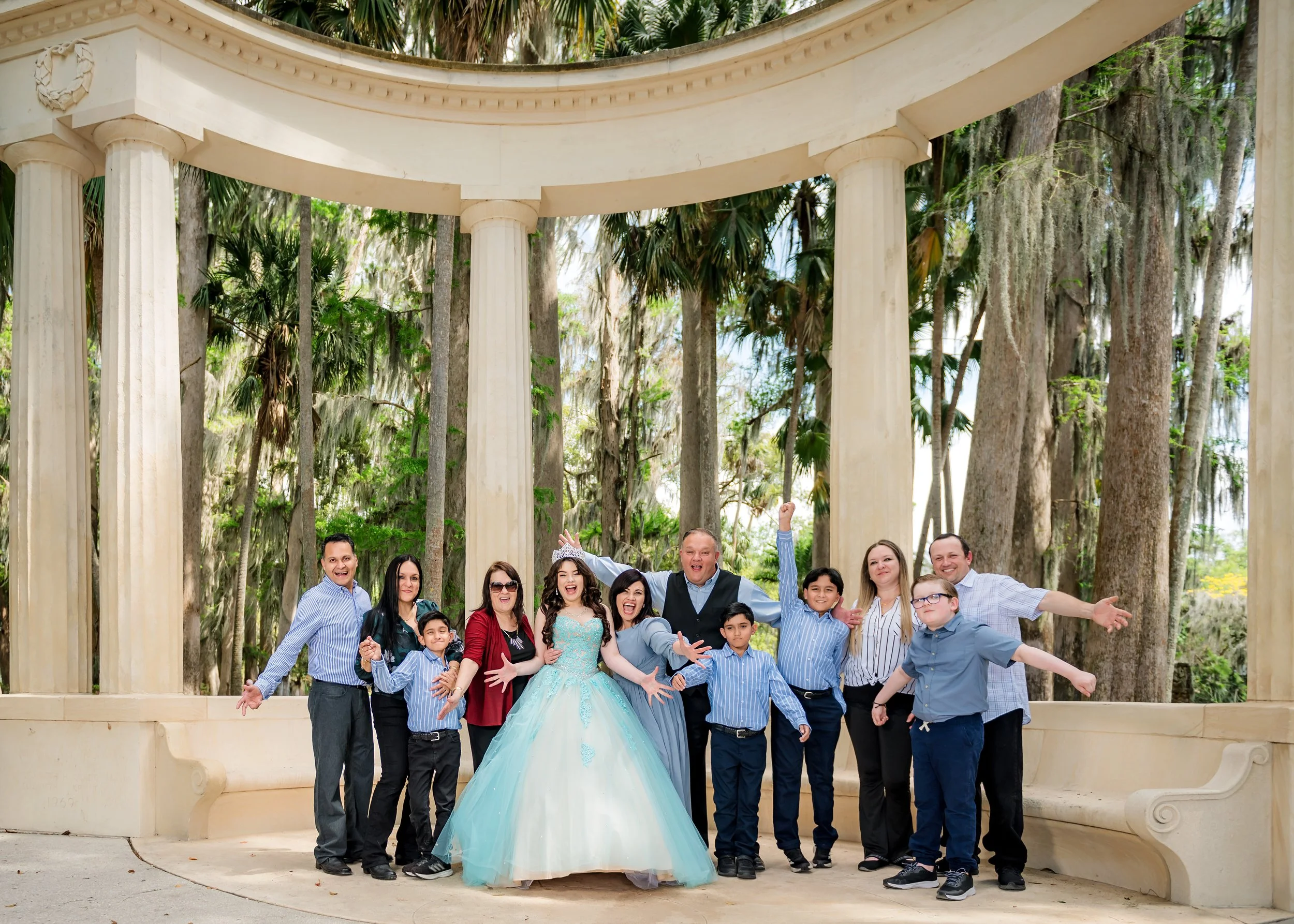 Family portrait with quinceañera in center at Kraft Azalea Garden in Winter Park ,Florida