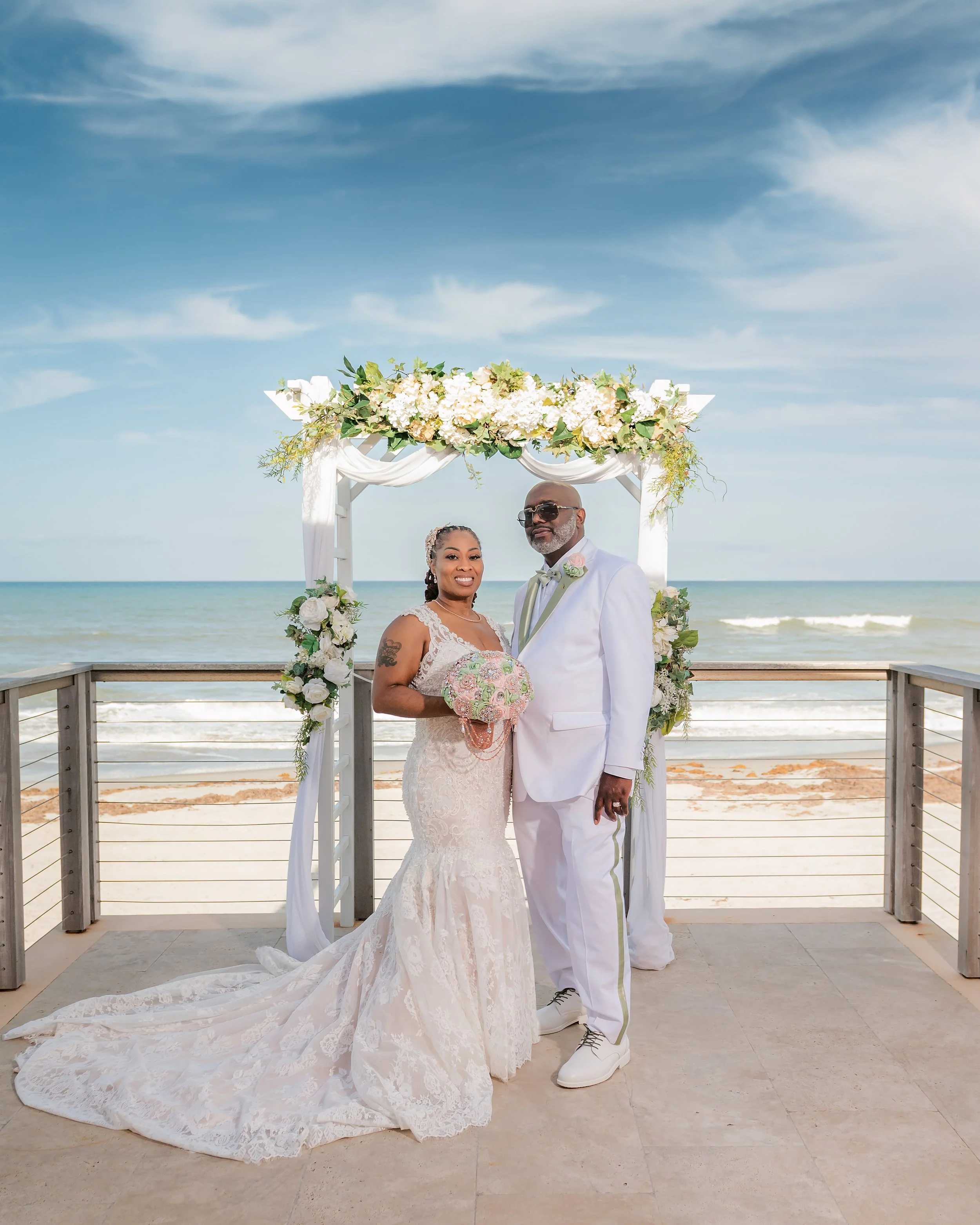 Bride and groom posing on beach at The Tides Club in Melbourne Beach, Florida, wedding portraits