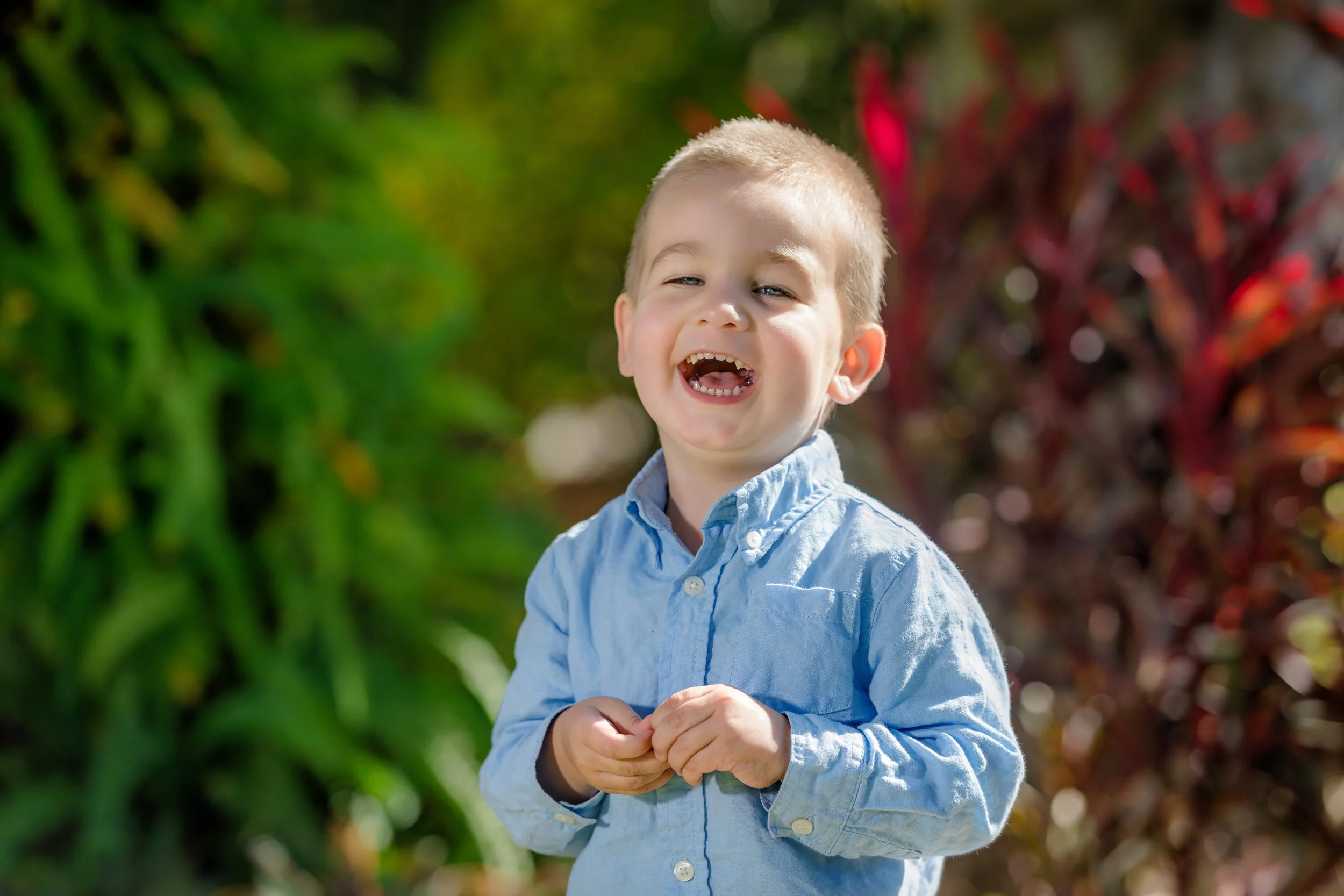 Little boy laughing during outdoor portrait session in Downtown Cocoa, Florida