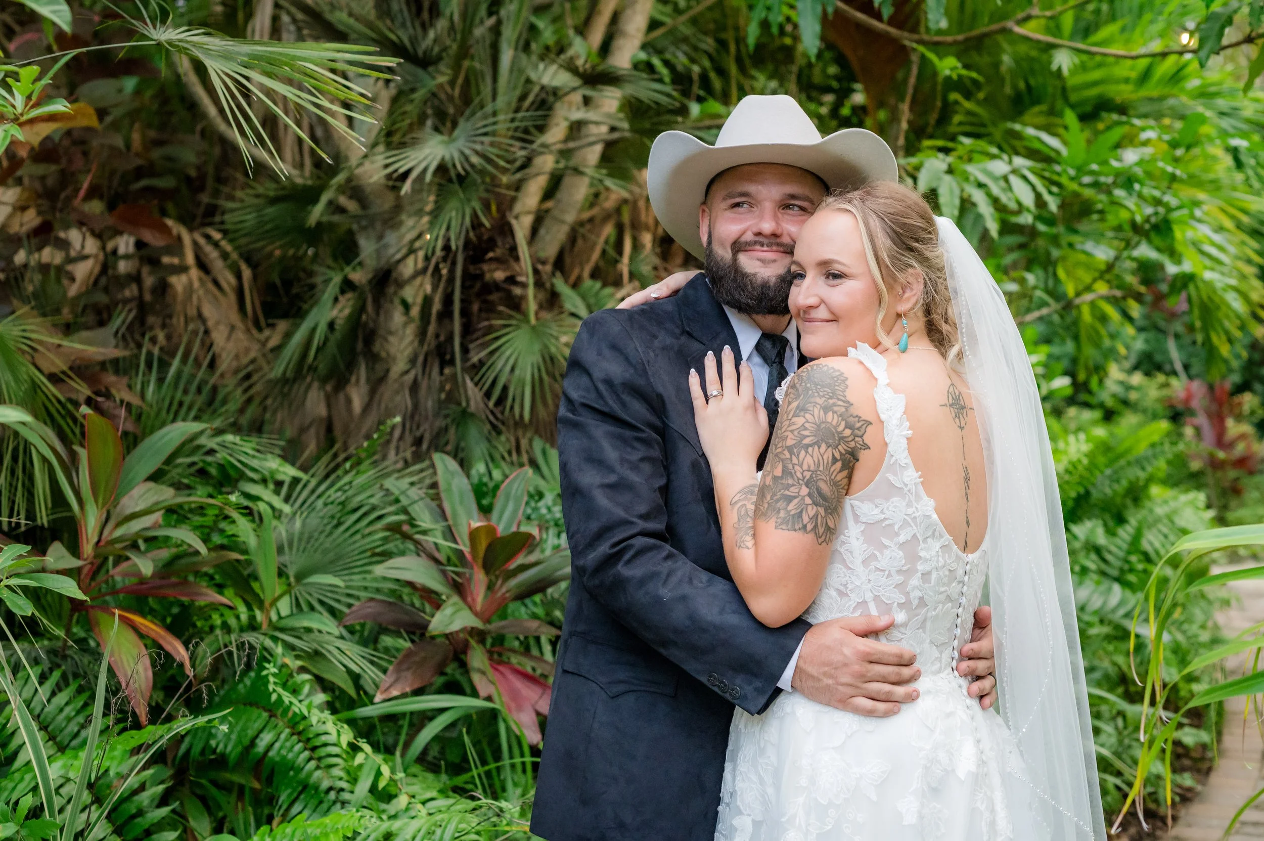 Bride and groom embracing at barn at Grant Station in Grant-Valkaria, Florida, wedding portraits