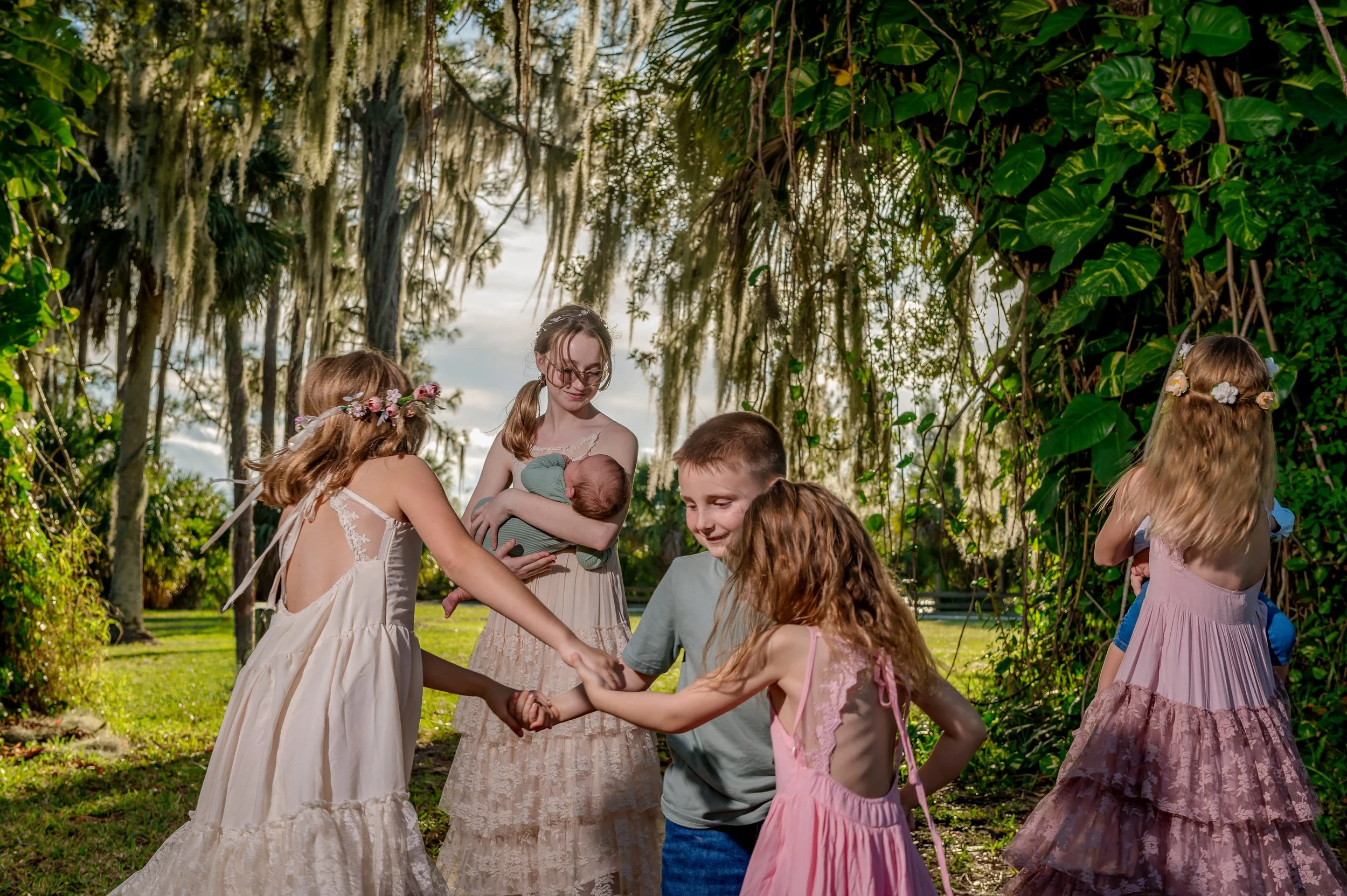 children dancing happily under tree