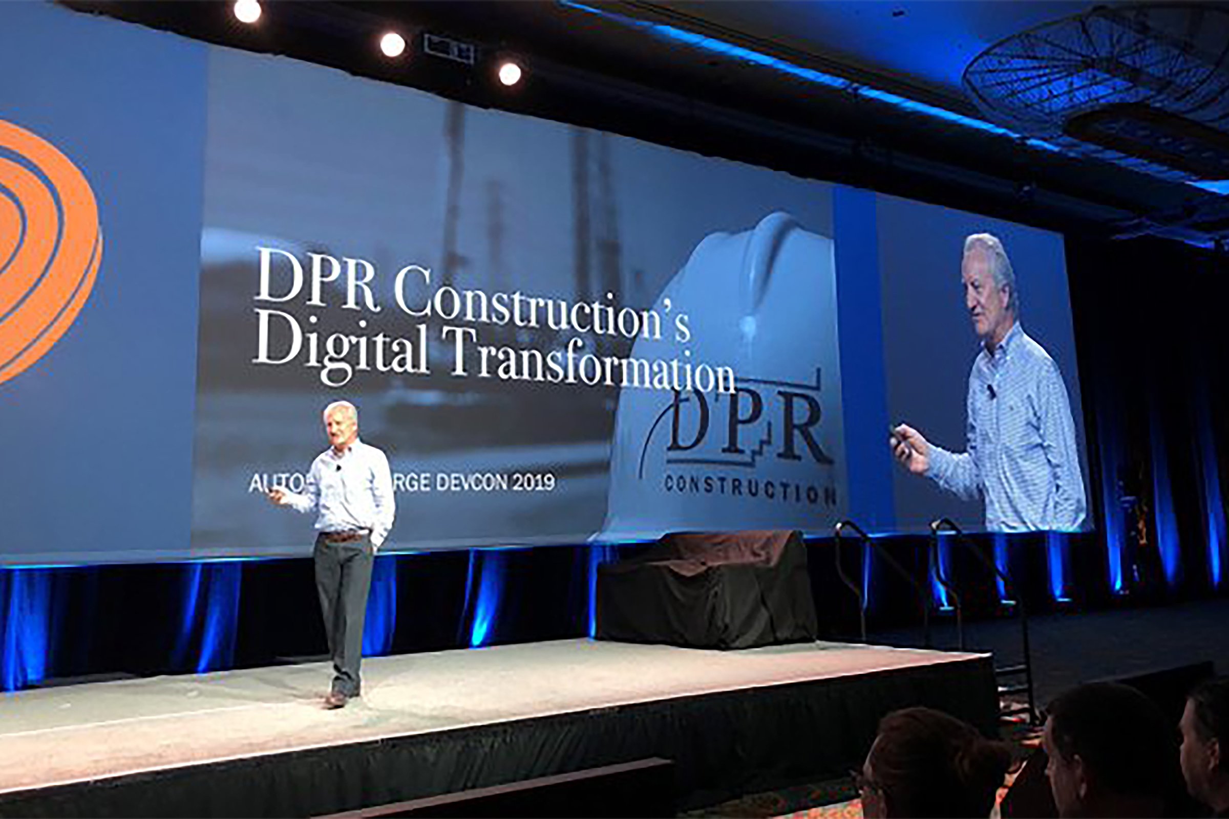 Stage presentation with digital screens at an event.