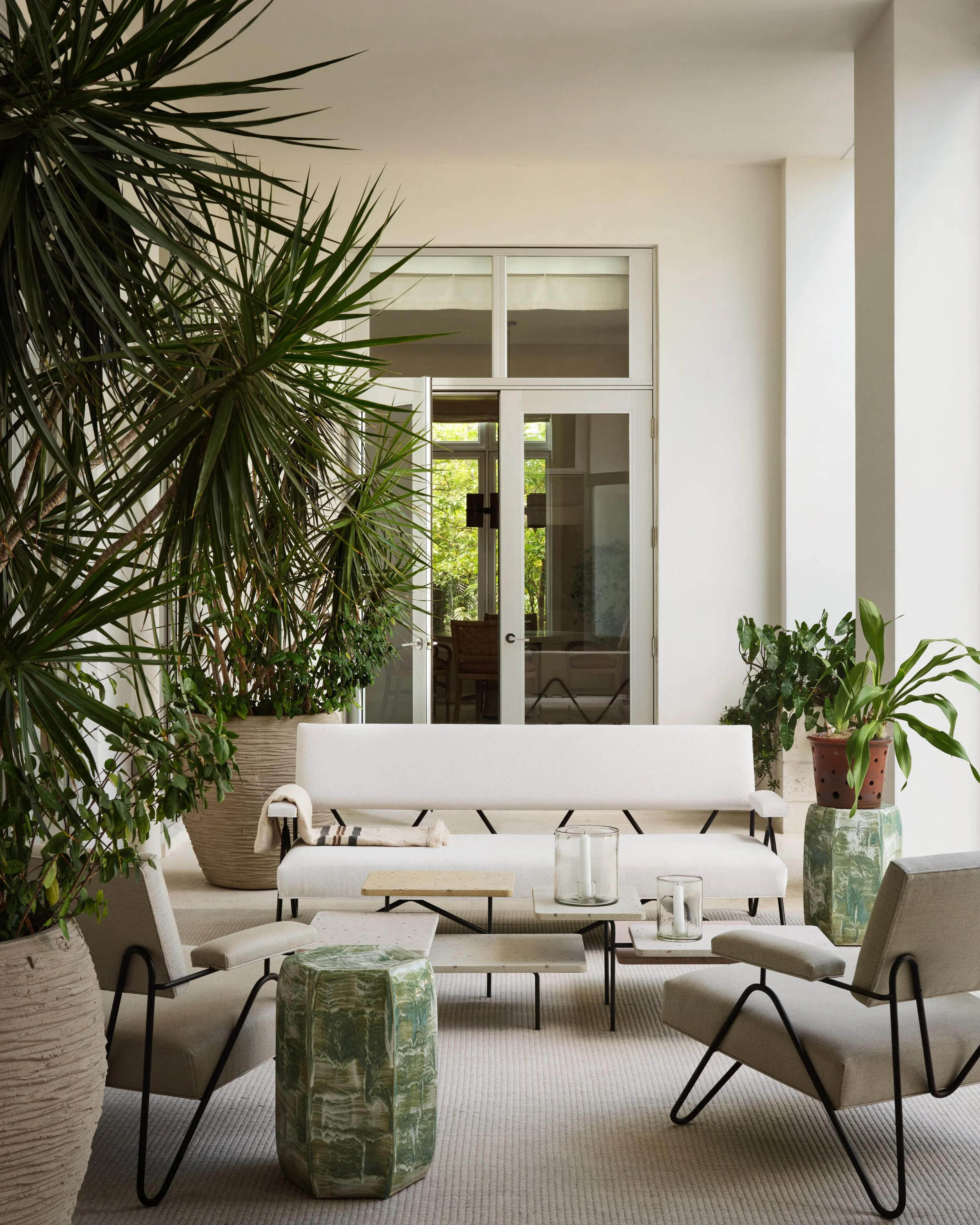 Outdoor seating area with two chairs and a bench.