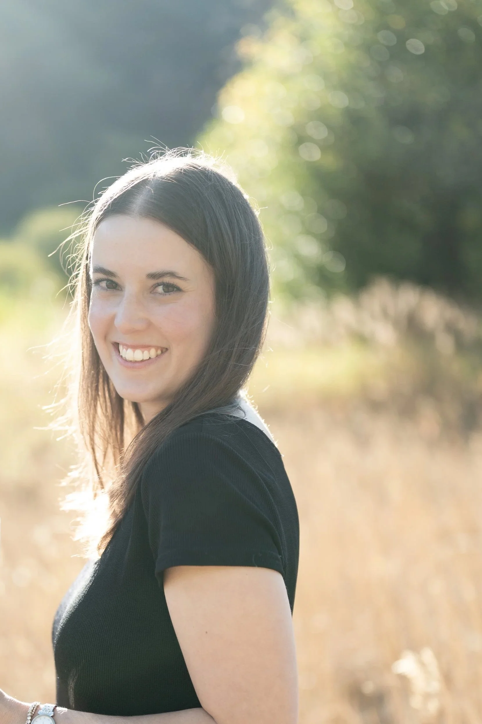 Headshot of Pam with black dress at dusk