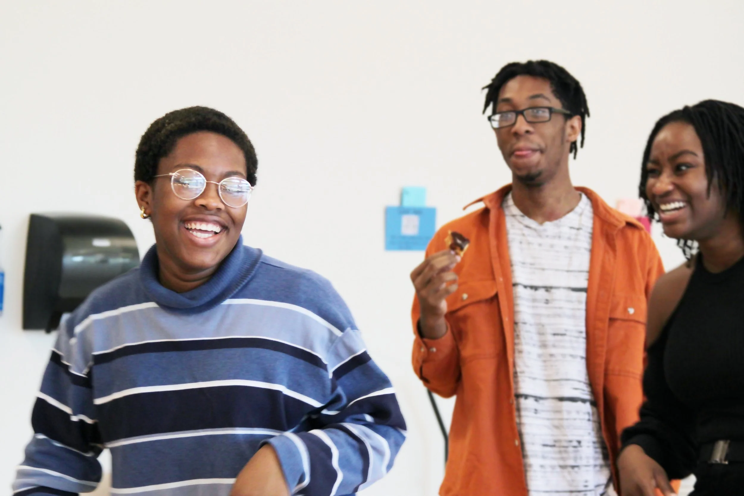 People smiling and welcoming others at Restore Houston Church