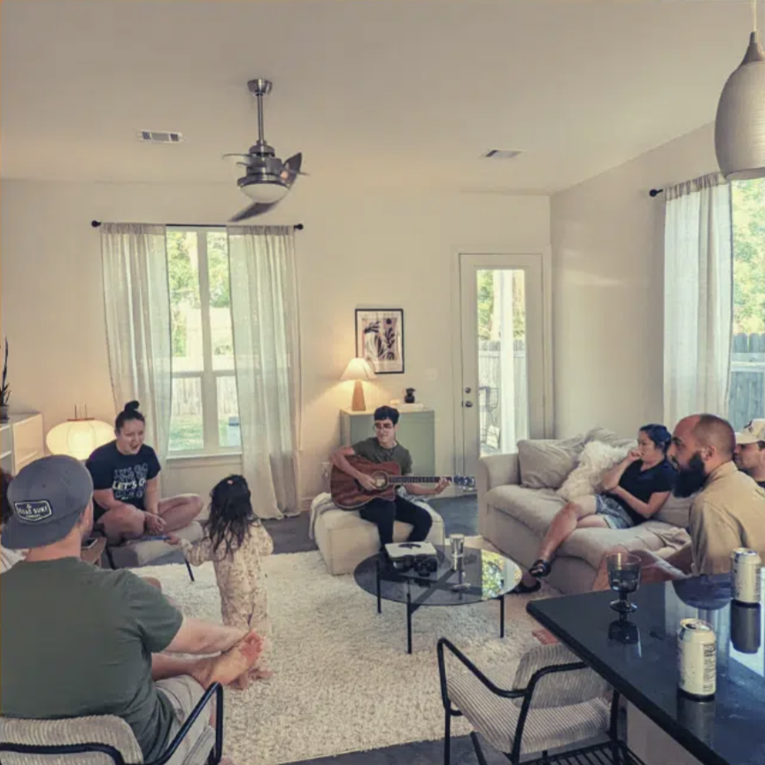People gathering in a Restore Houston Church small group in a living room