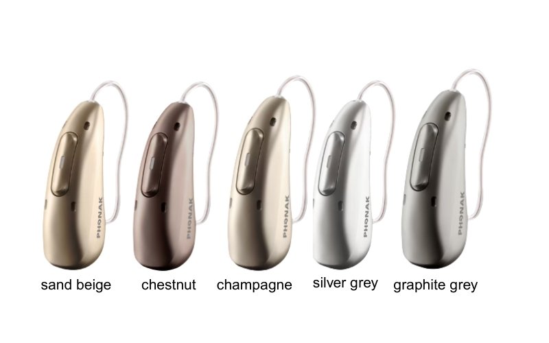 A row of five Phonak Infinio hearing aids in different colors: sand beige, chestnut, champagne, silver grey, and graphite grey.