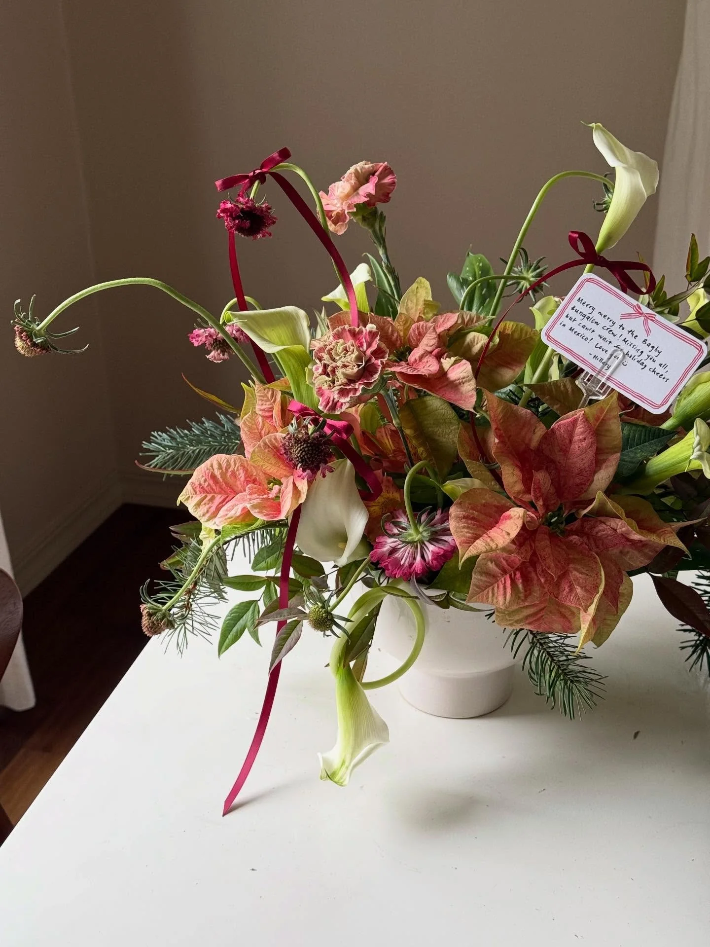 first holiday arrangement out the door today with curled callalilies, poinsettias, scabiosas, antique carnations, and bows for a touch of festive and fun!