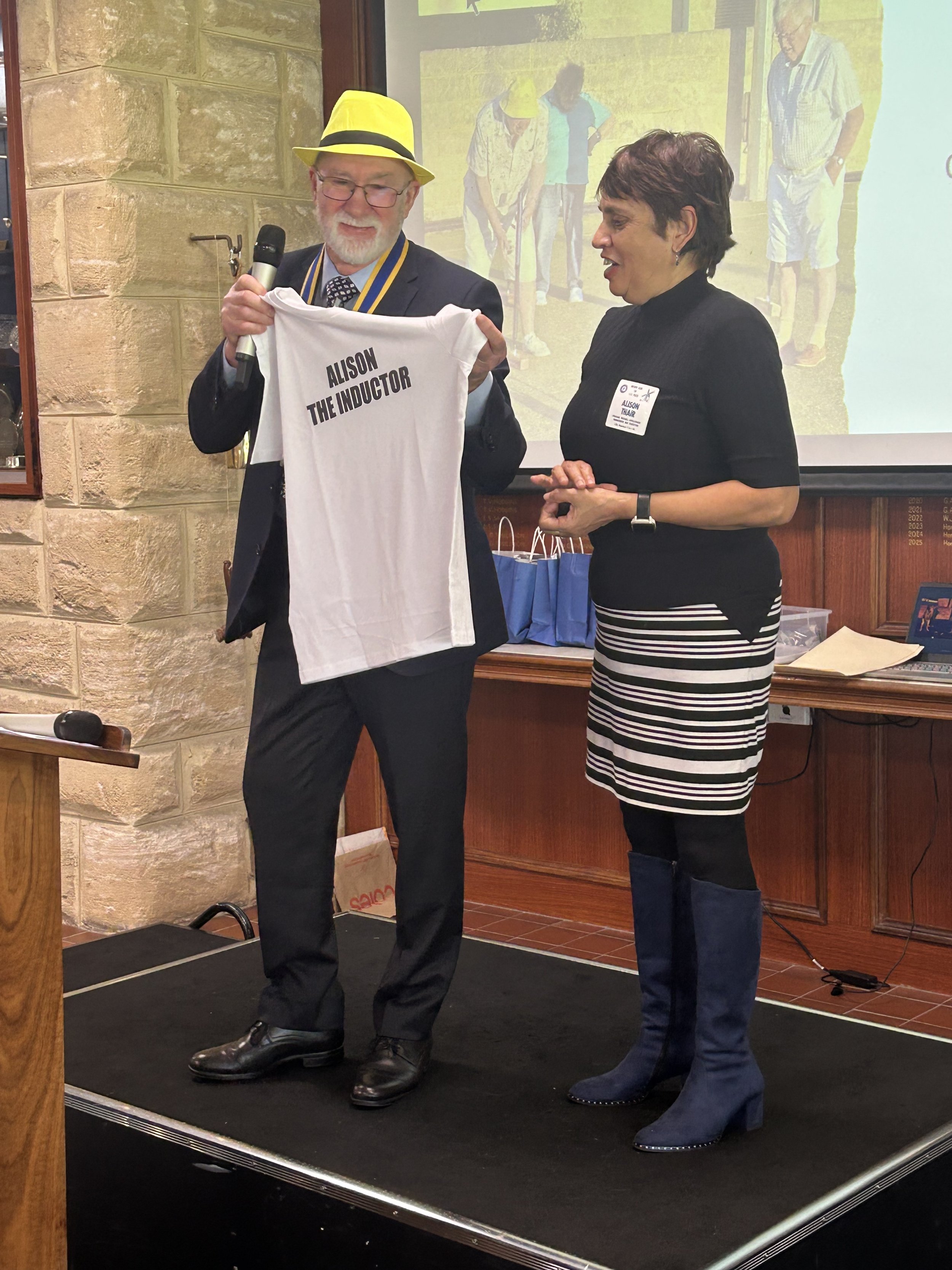 Alison receiving her "Inductinator" T-shirt from Kelly